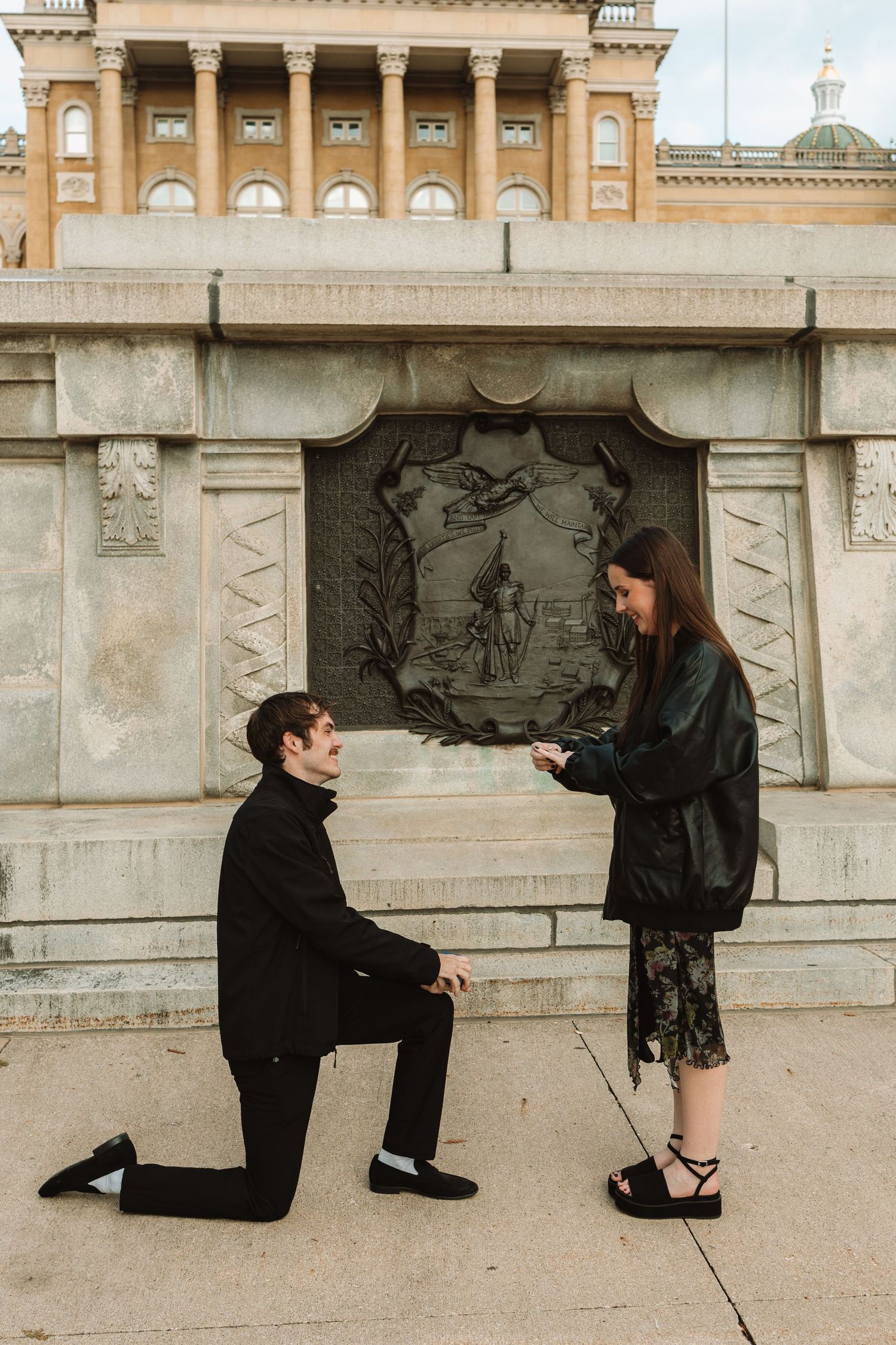 A sequence of four photos showing a romantic proposal moment along a stone wall in vintage style photography.