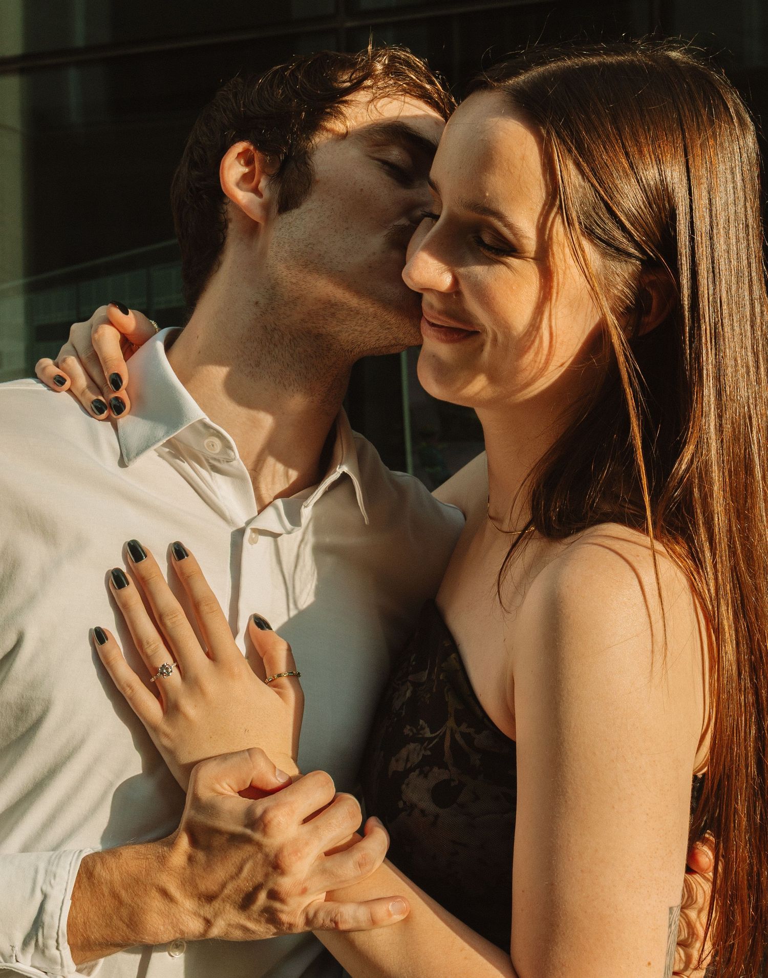 Romantic couple sharing intimate moments in a series of tender poses against a dark background.