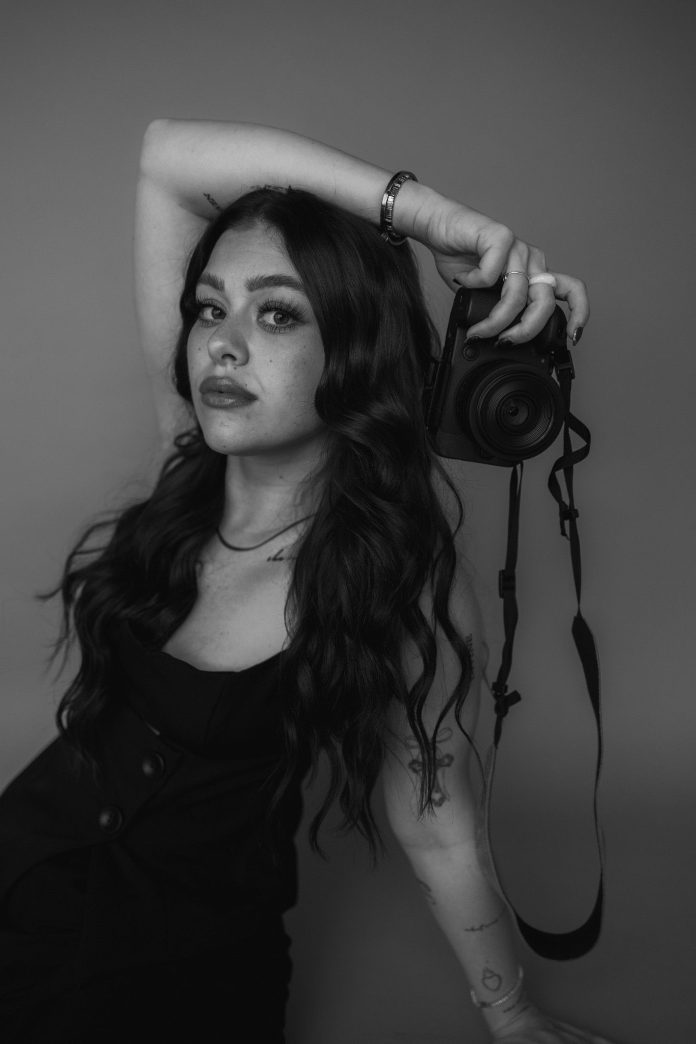 Artistic black and white portraits showing various poses with long dark hair.