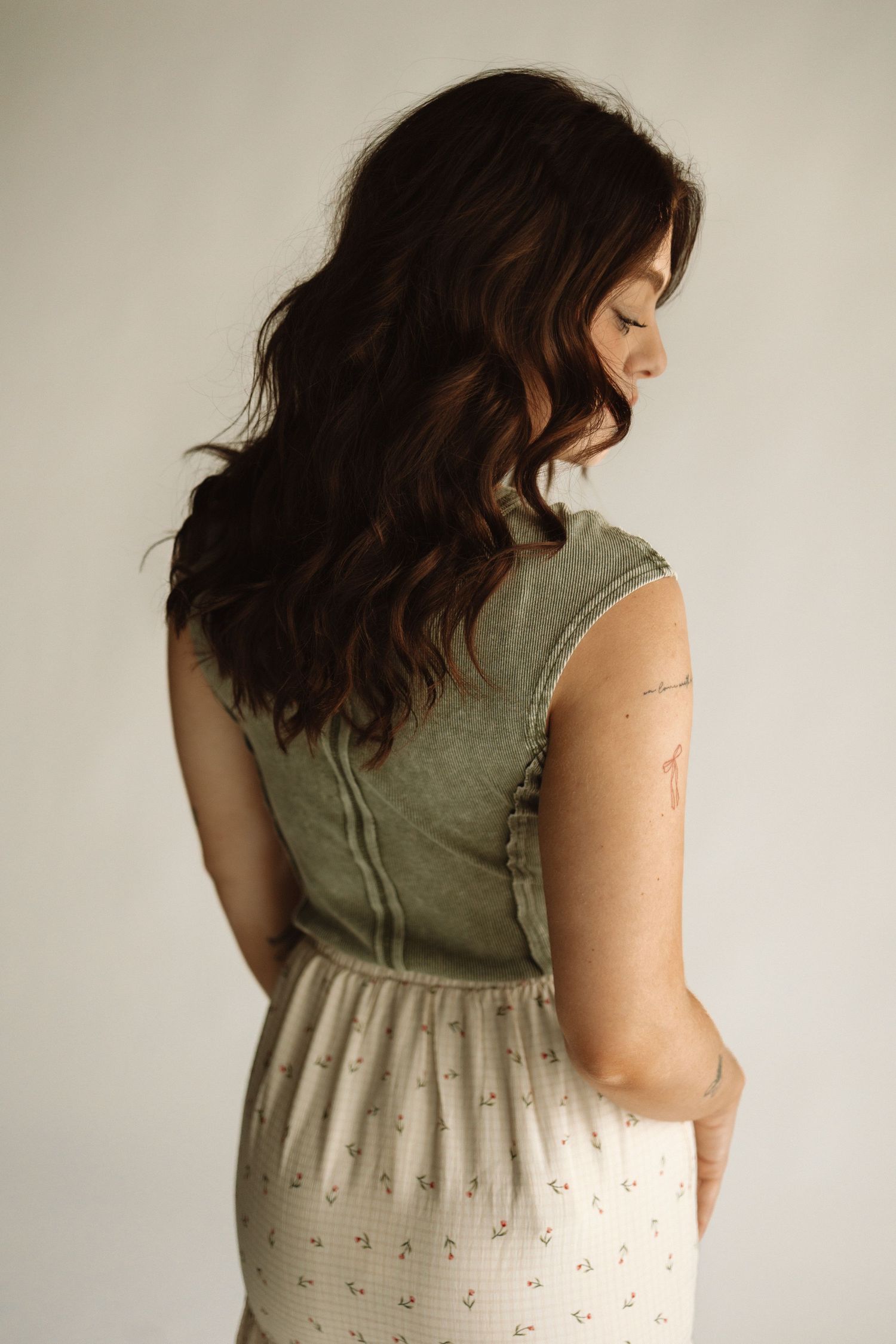 Sleeveless dress with olive bodice and cream eyelet skirt shown from multiple back view angles.