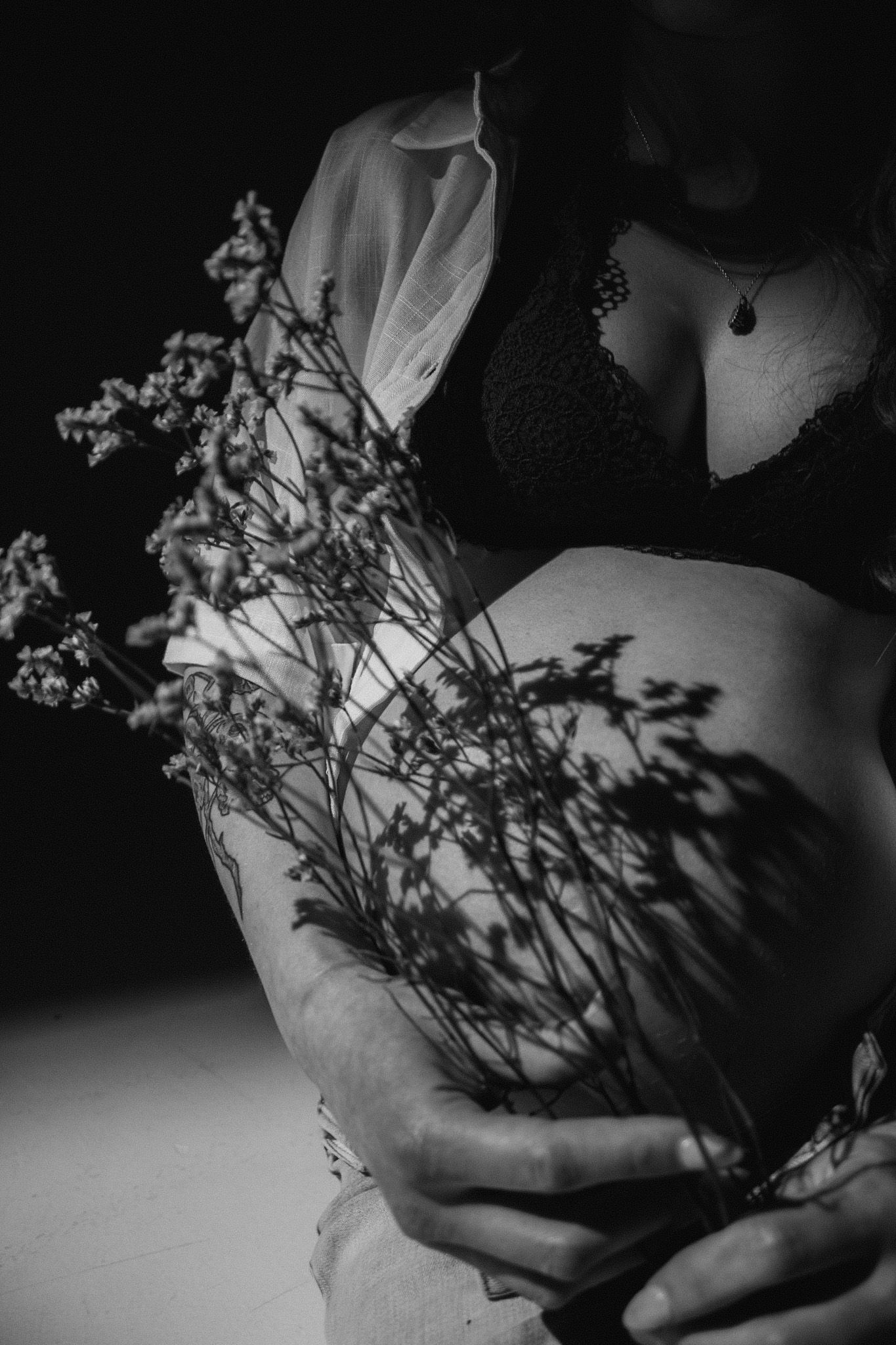 Artistic black and white close-up of flowers creating dramatic shadows.