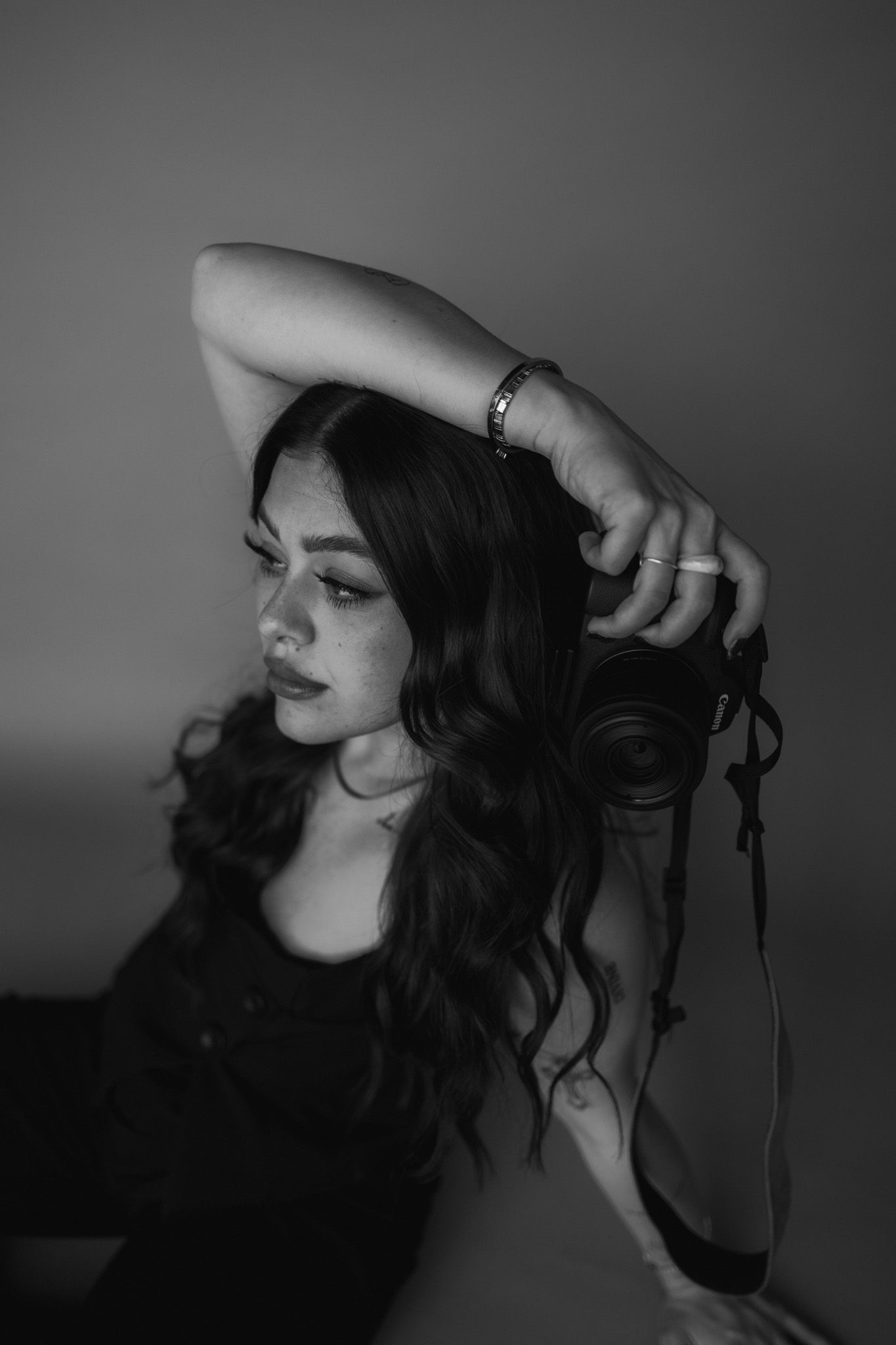 Dramatic black and white portrait showing long wavy hair and artistic lighting.