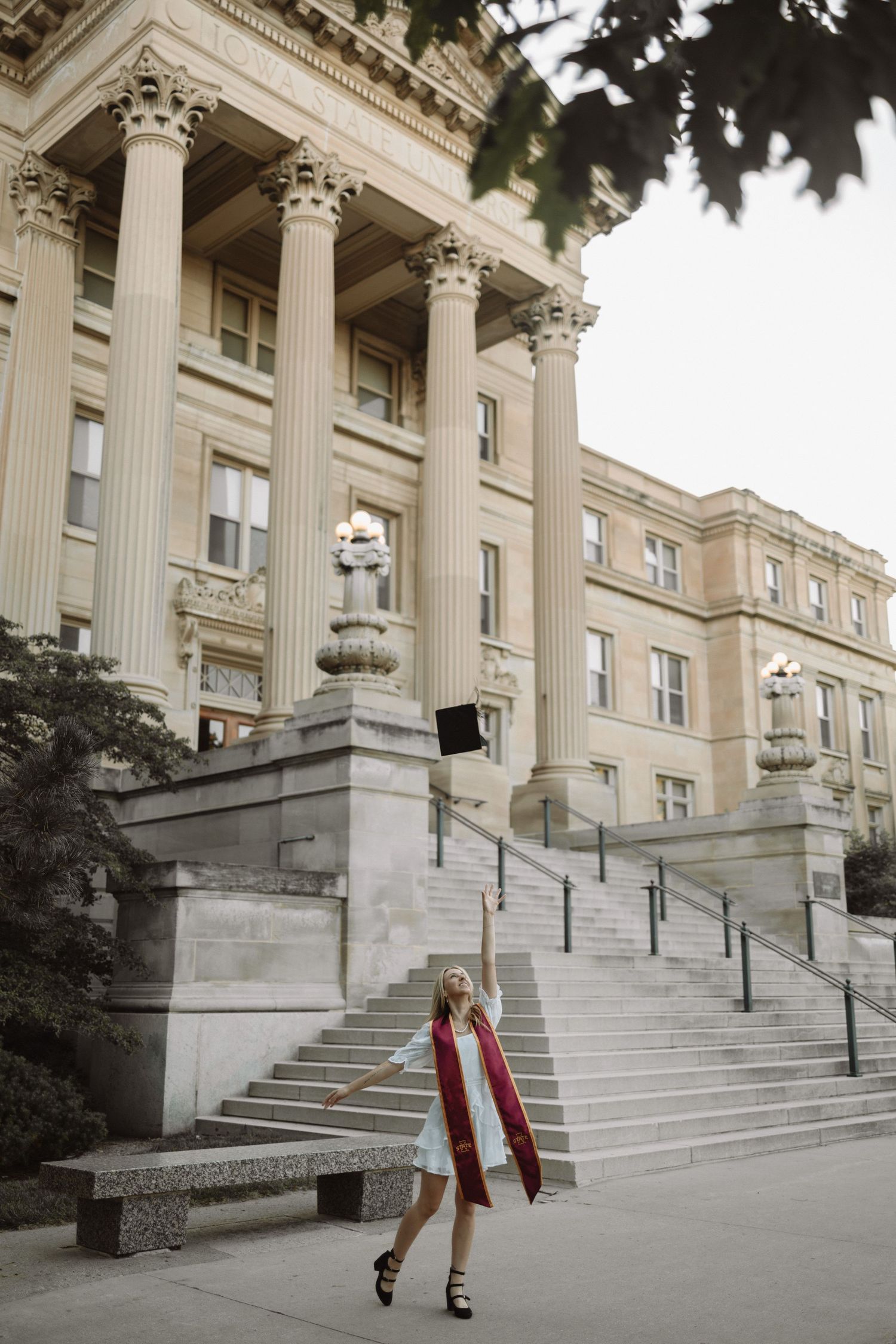 A series of three images showing someone walking down grand stone steps of a neoclassical building with columns.
