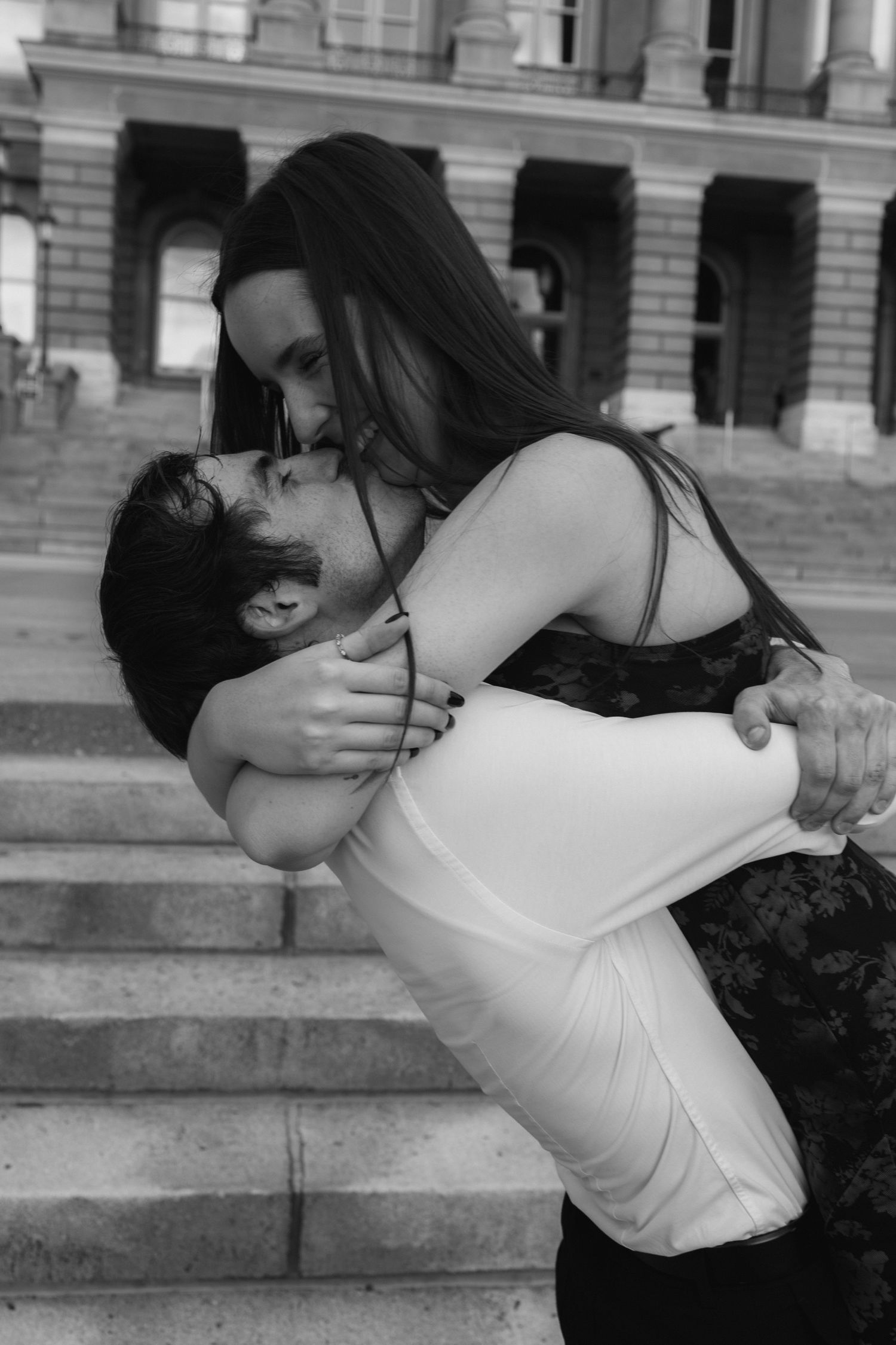 A black and white photo sequence shows a romantic embrace between two people on stone steps.
