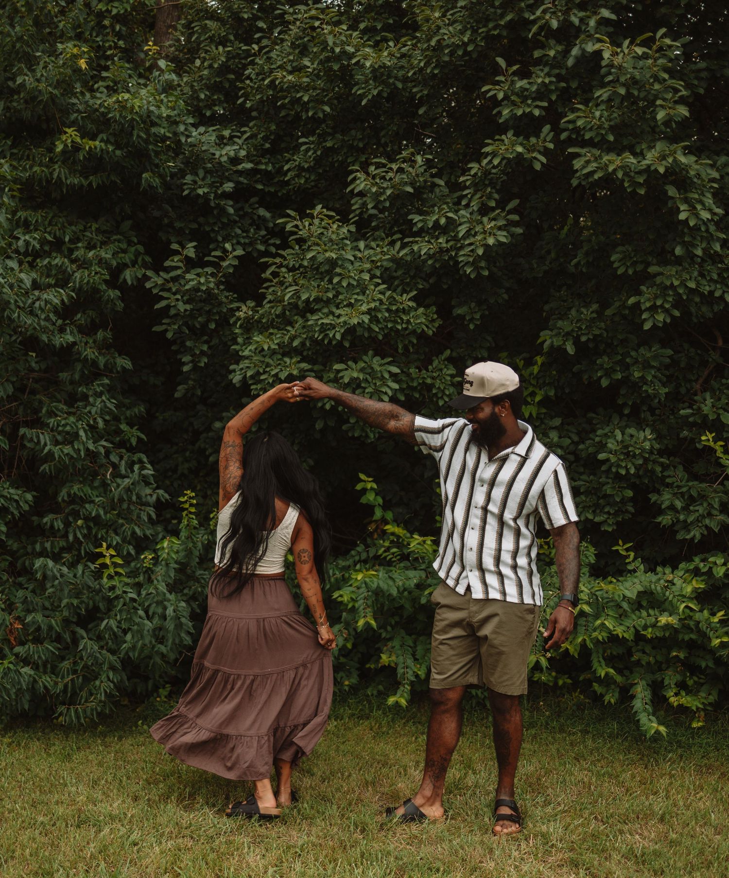 Stylized photoshoot sequence showing legs in brown dress and striped shirt walking across grassy outdoor setting.