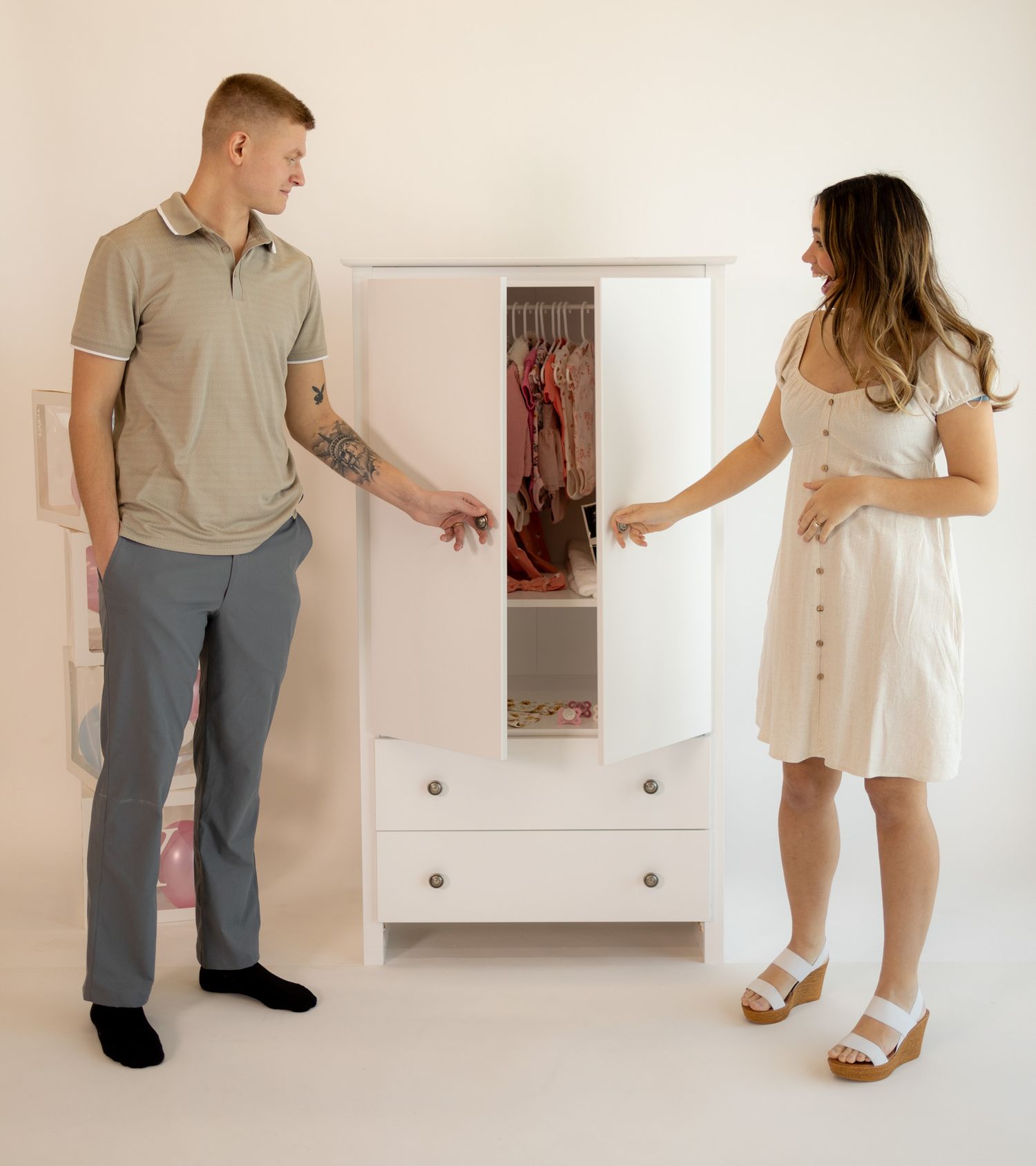 A couple in matching beige and gray outfits poses in five different casual stances against a white wall.