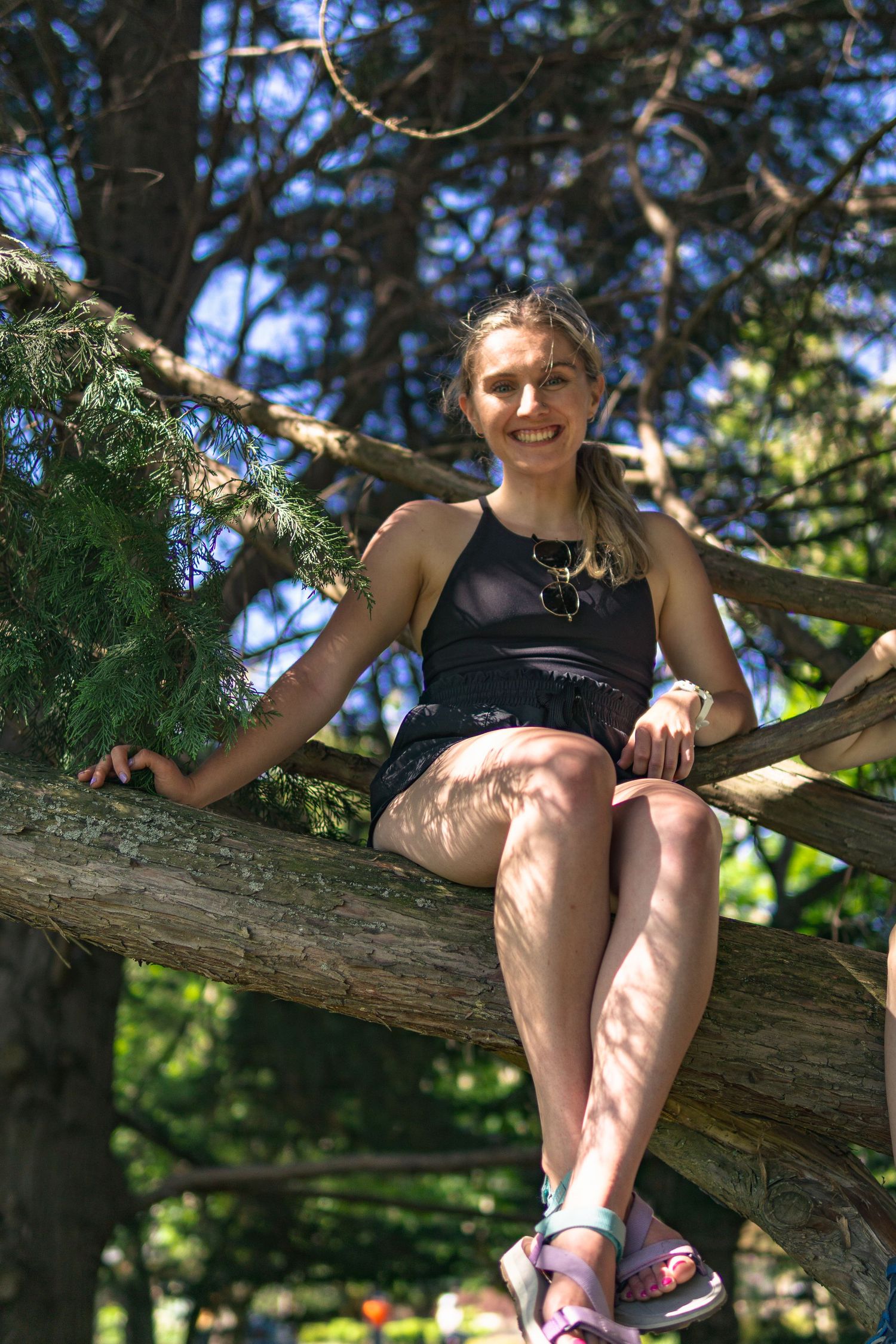 Natural portrait of a woman on the tree trunk in the park in Victoria