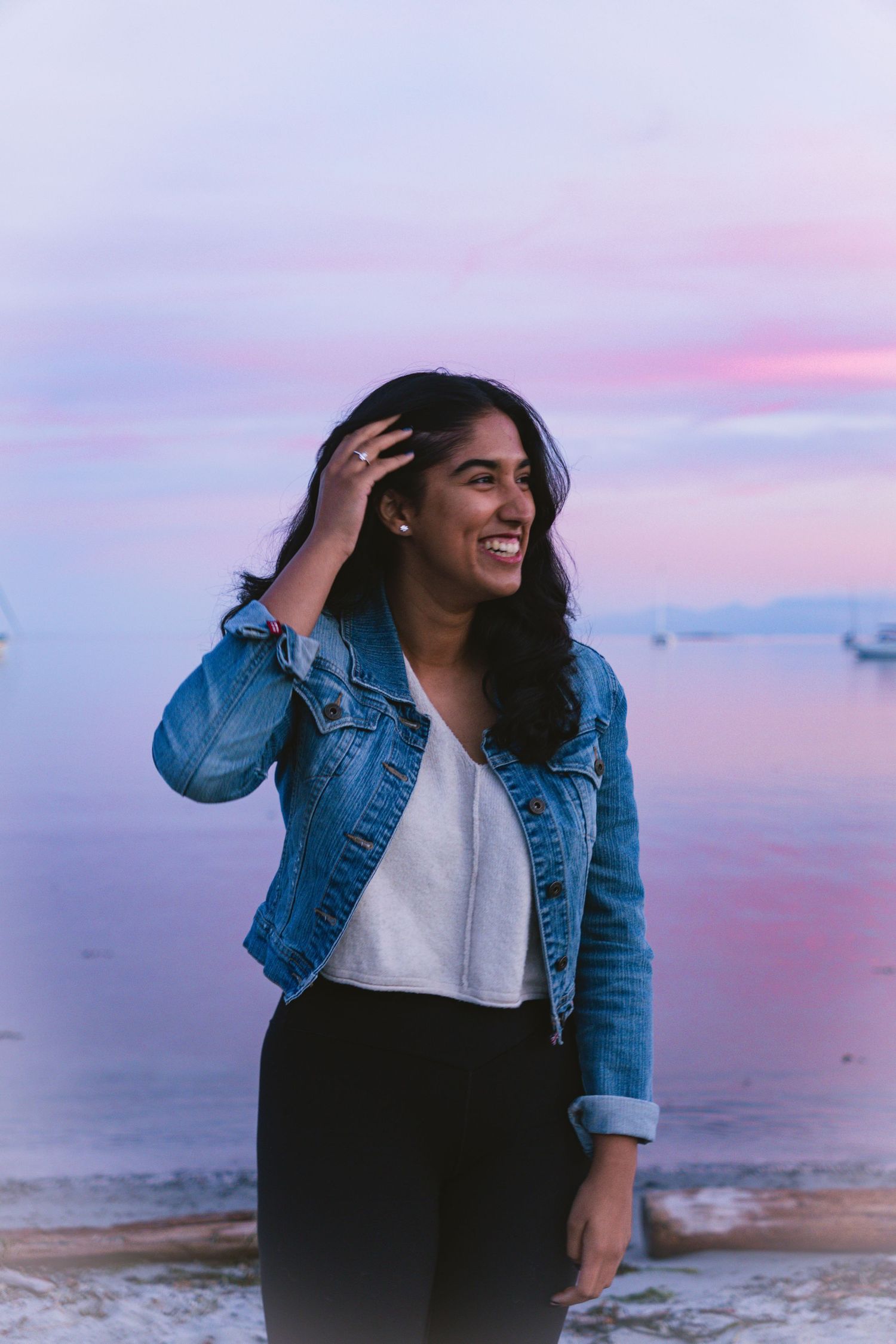 Pink evening light close-up of a women smiling during sunset shoot in Cadboro-Gyro park in Victoria