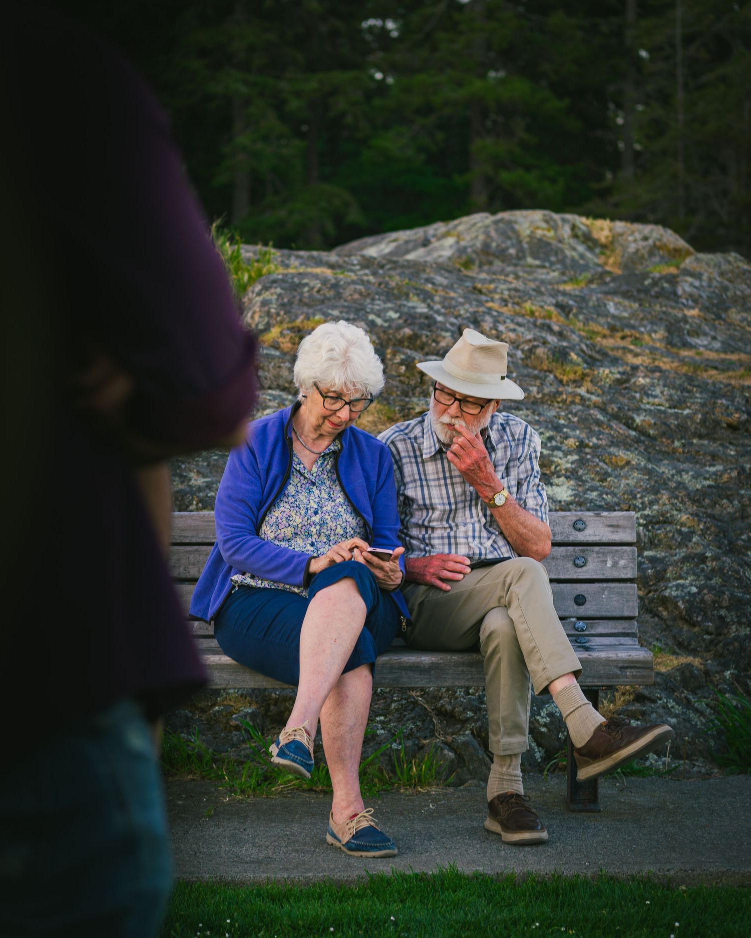 Senior couple on a park bench at the sunset evening hour