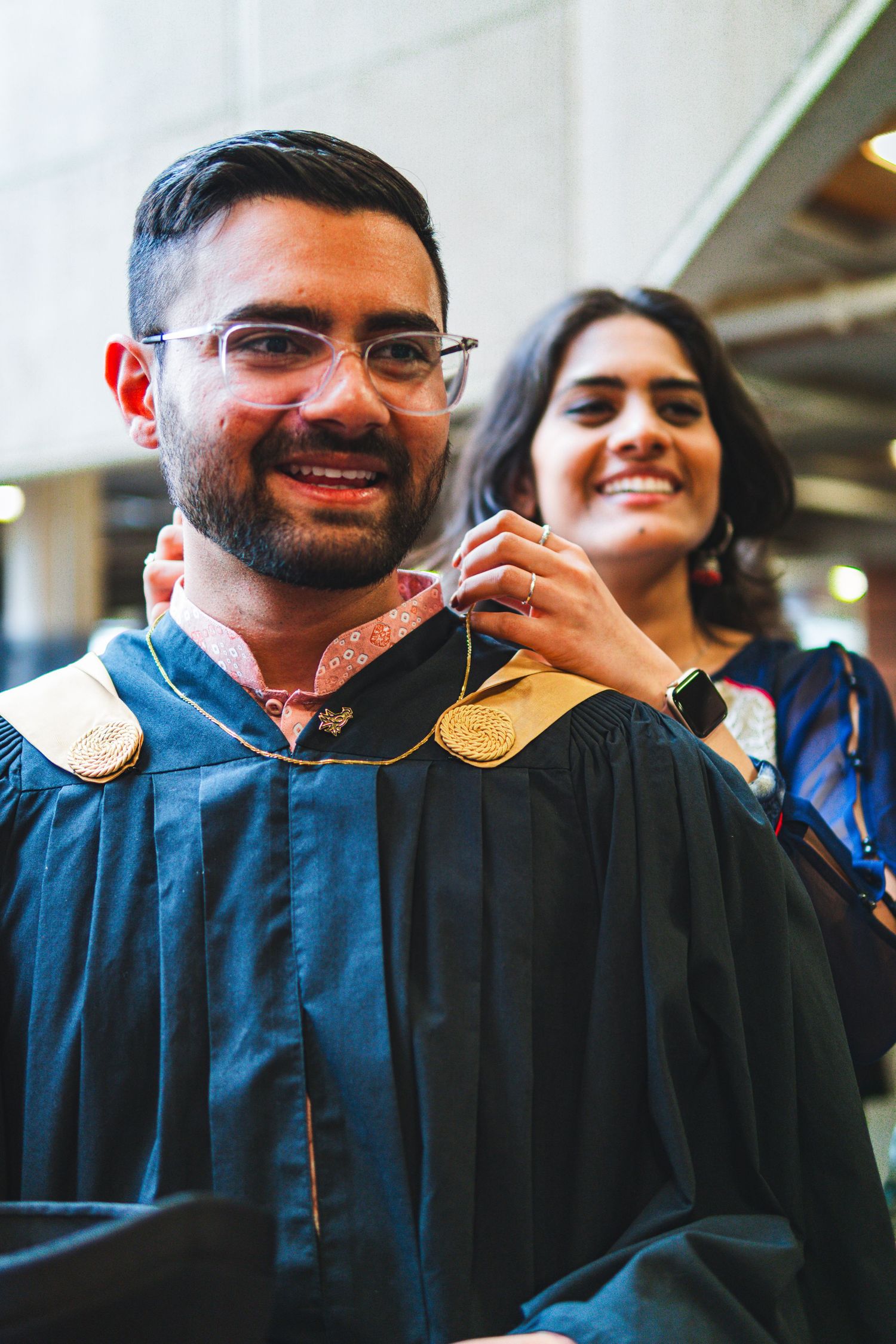 UVic graduate with his sister posing happily