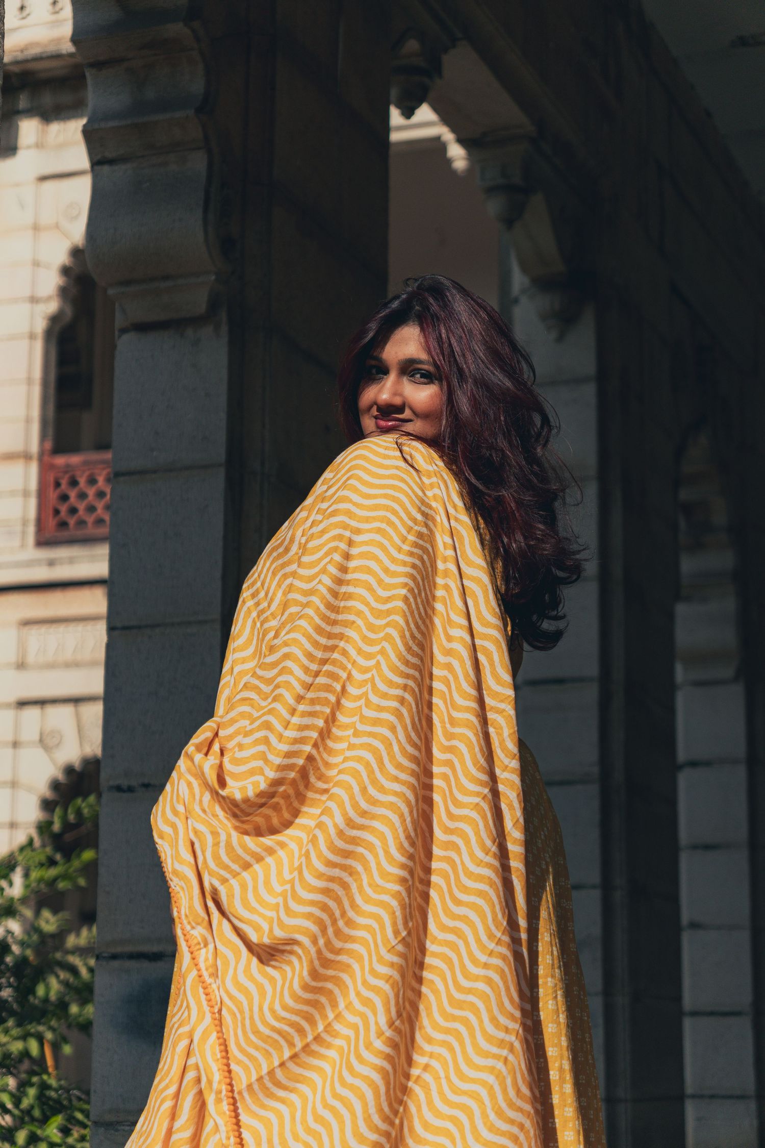 Modern Indian look in yellow dress in historical palace in Vadodara, Gujarat, India