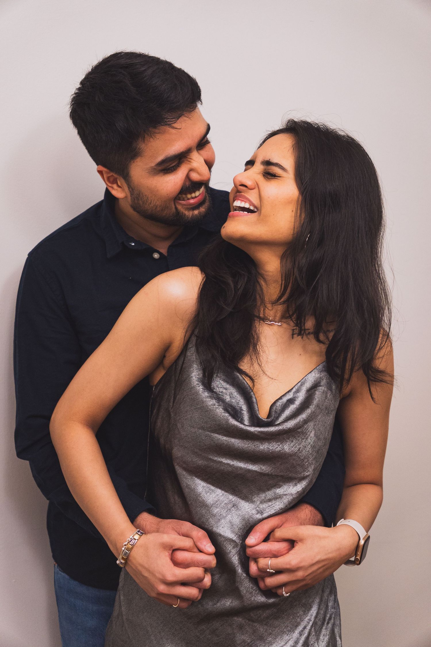 Warm and funny candid of couple laughing during intimate indoor session in Vancouver, Canada