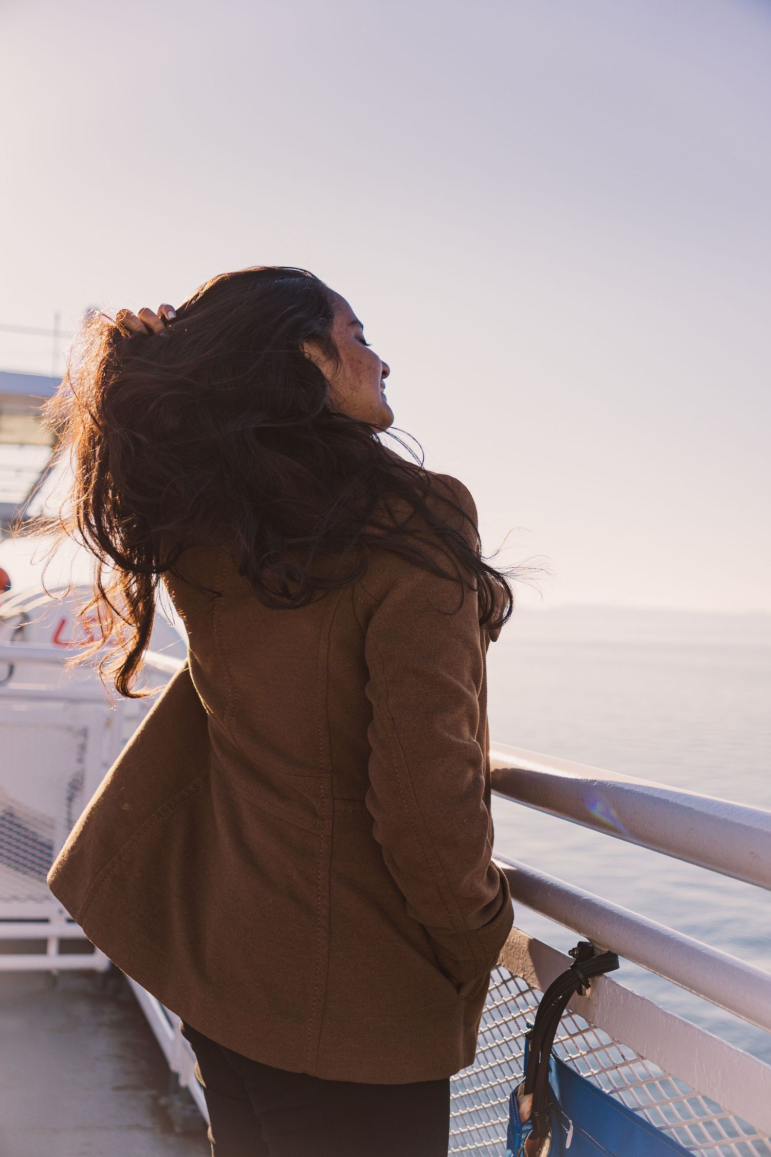 Natural light candid of woman laughing during BC coastal ferry ride from Victoria to Vancouver