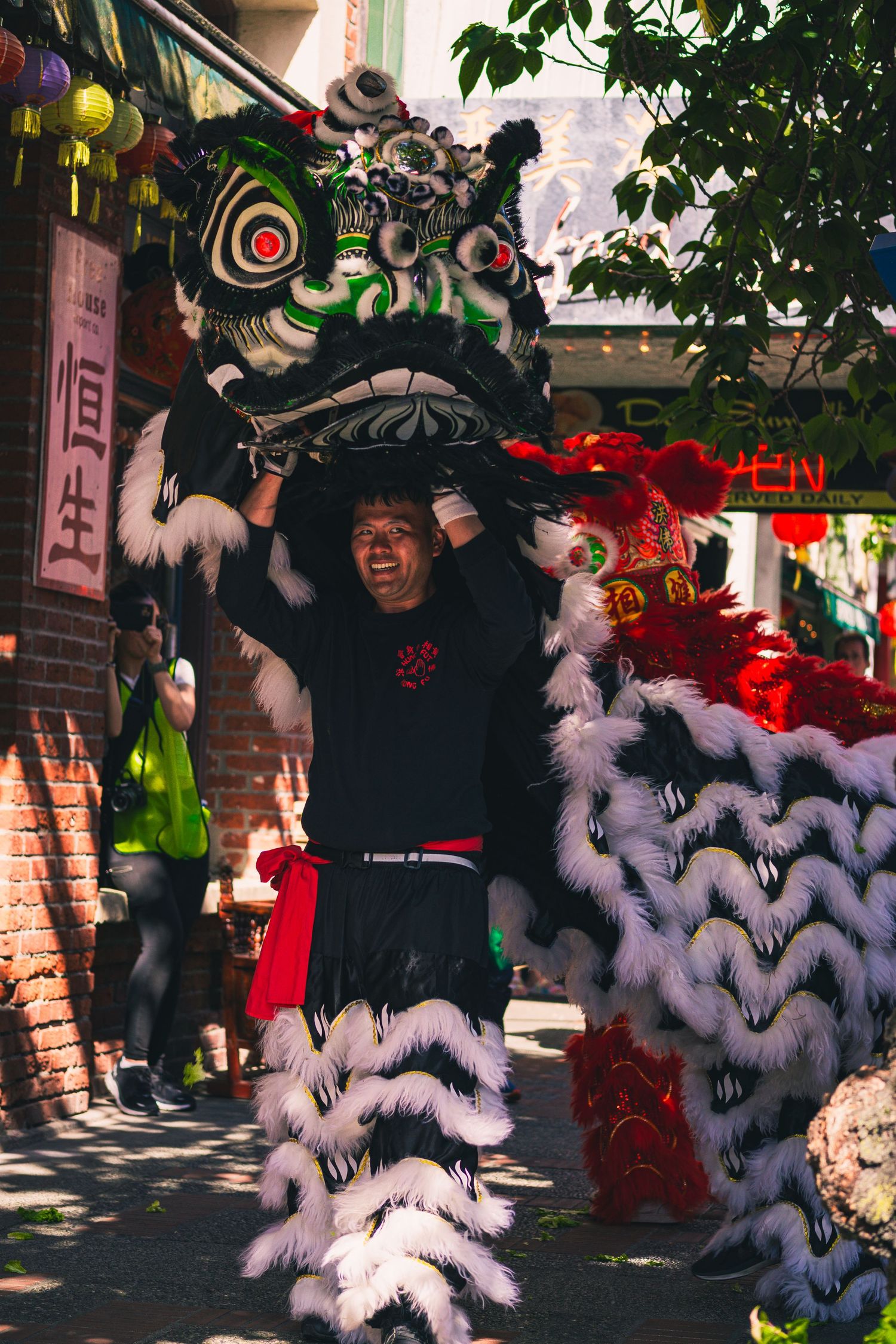 Natural candid portrait of men doing traditional lion dance performance at Awakening Chinatown in Victoria