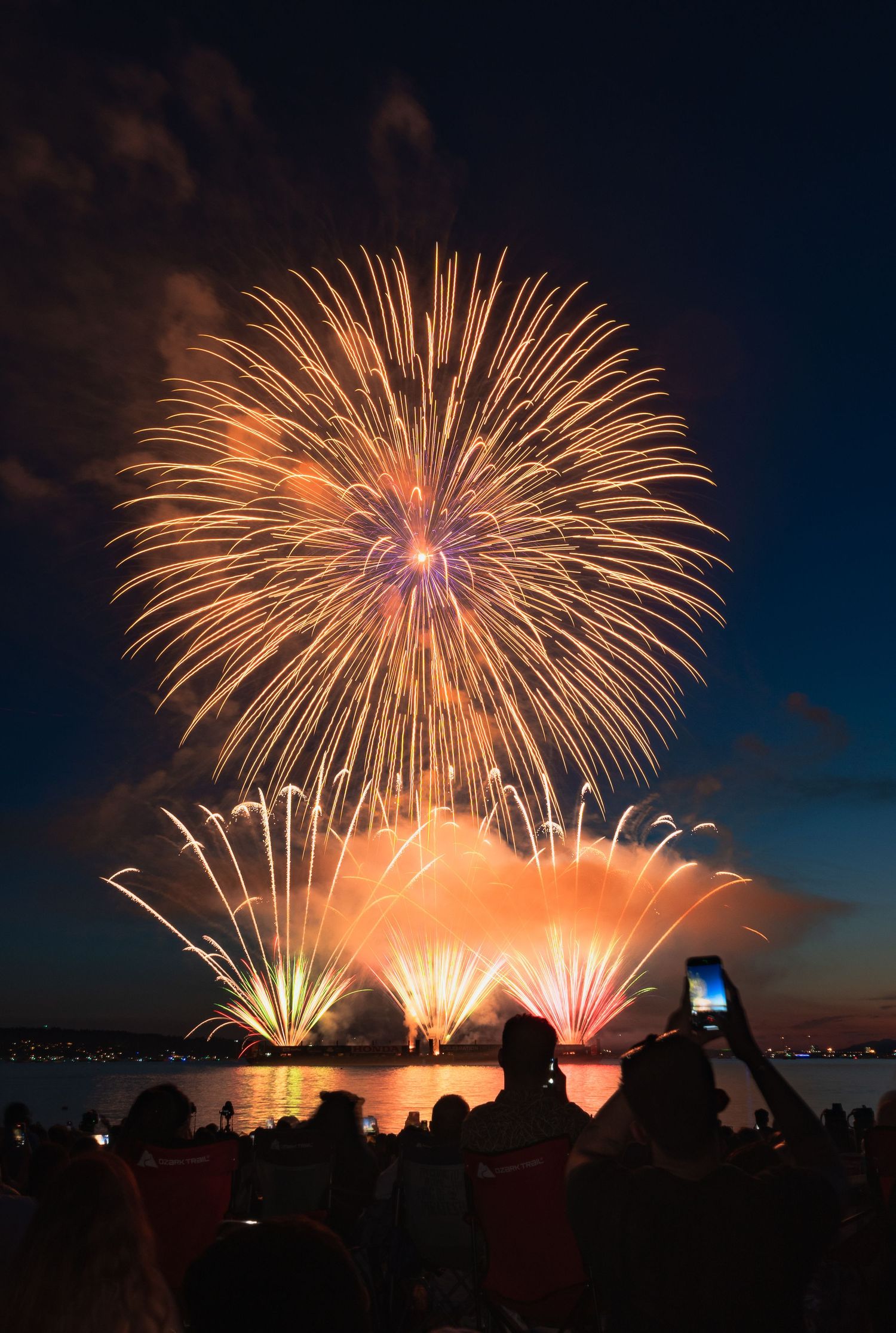 Colorful fireworks illuminating ocean waves during summer celebration