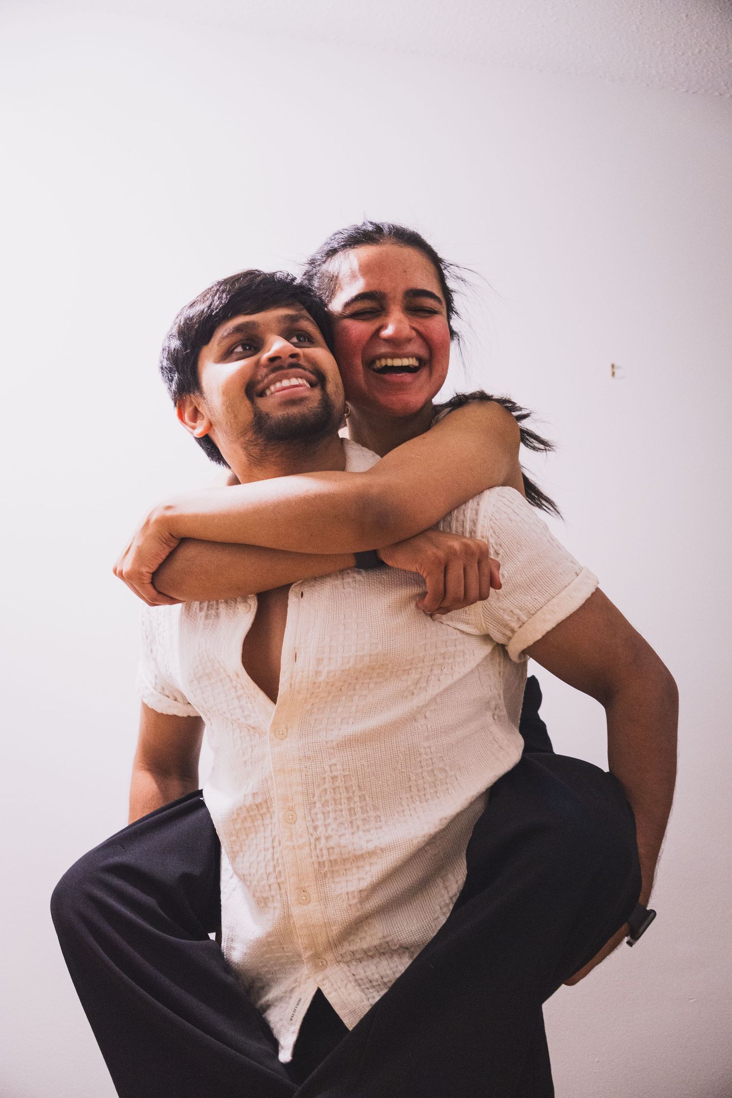 Authentic moment of couple cracking up during an in-home photo shoot