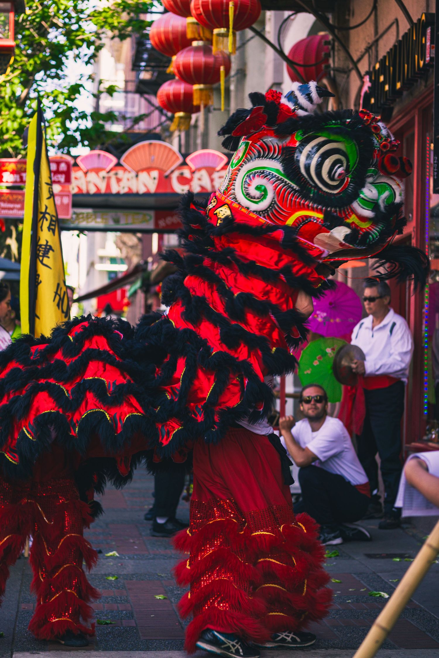Performer in traditional red robe smiling before cultural dance