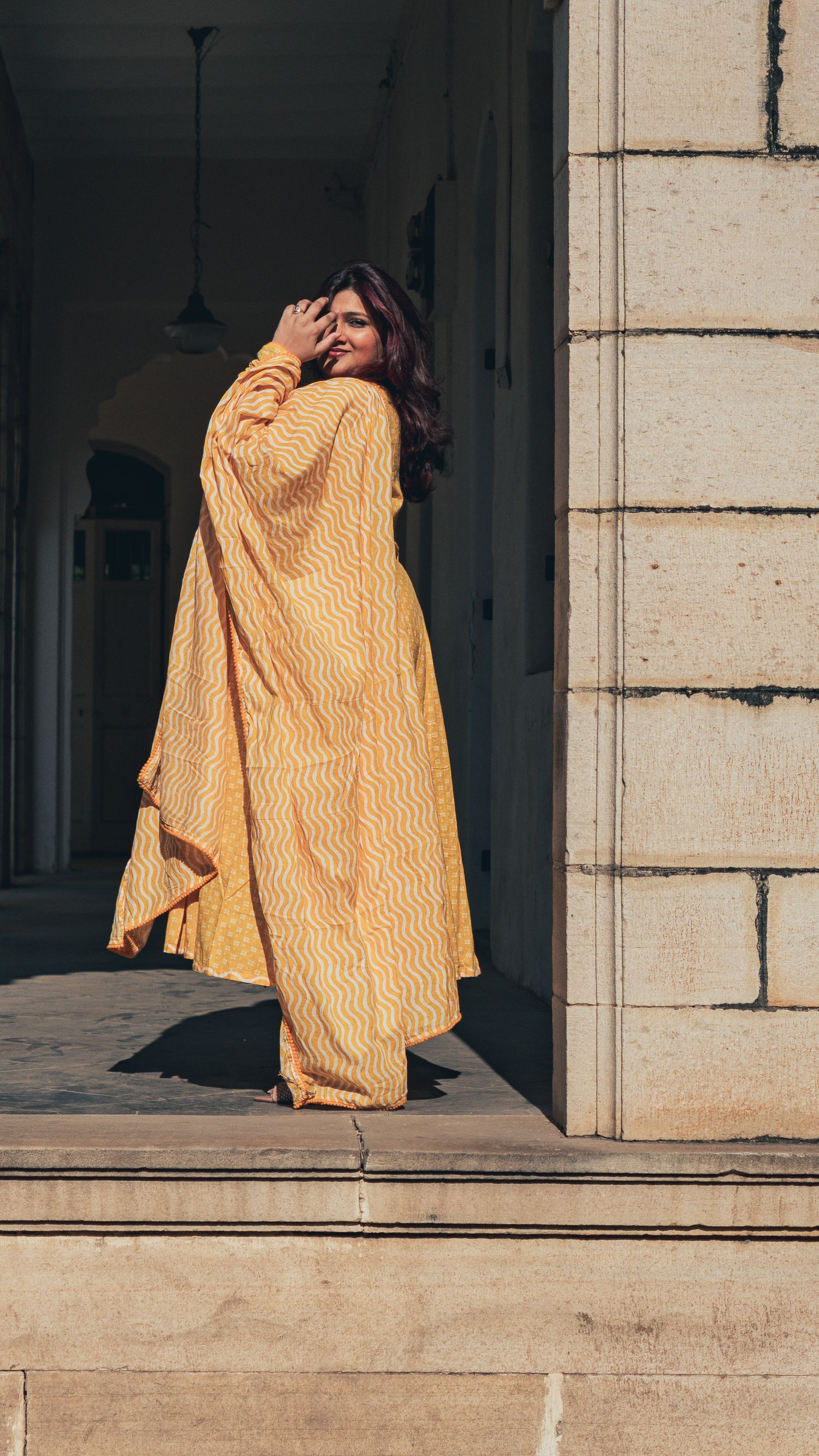 Modern Indian look in yellow dress in historical palace in Vadodara, Gujarat, India
