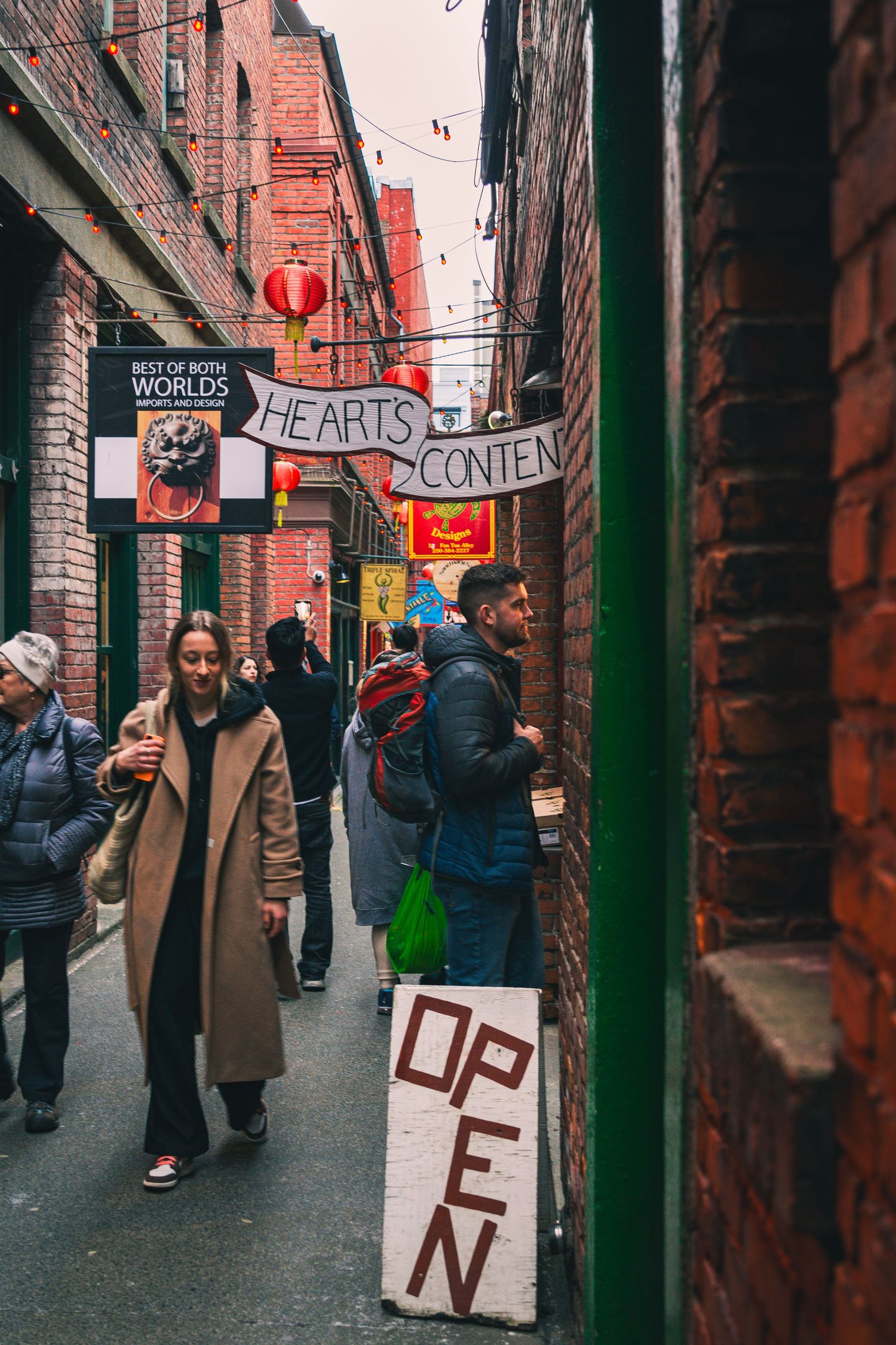 People stopping to read historical Chinatown markers and plaques
