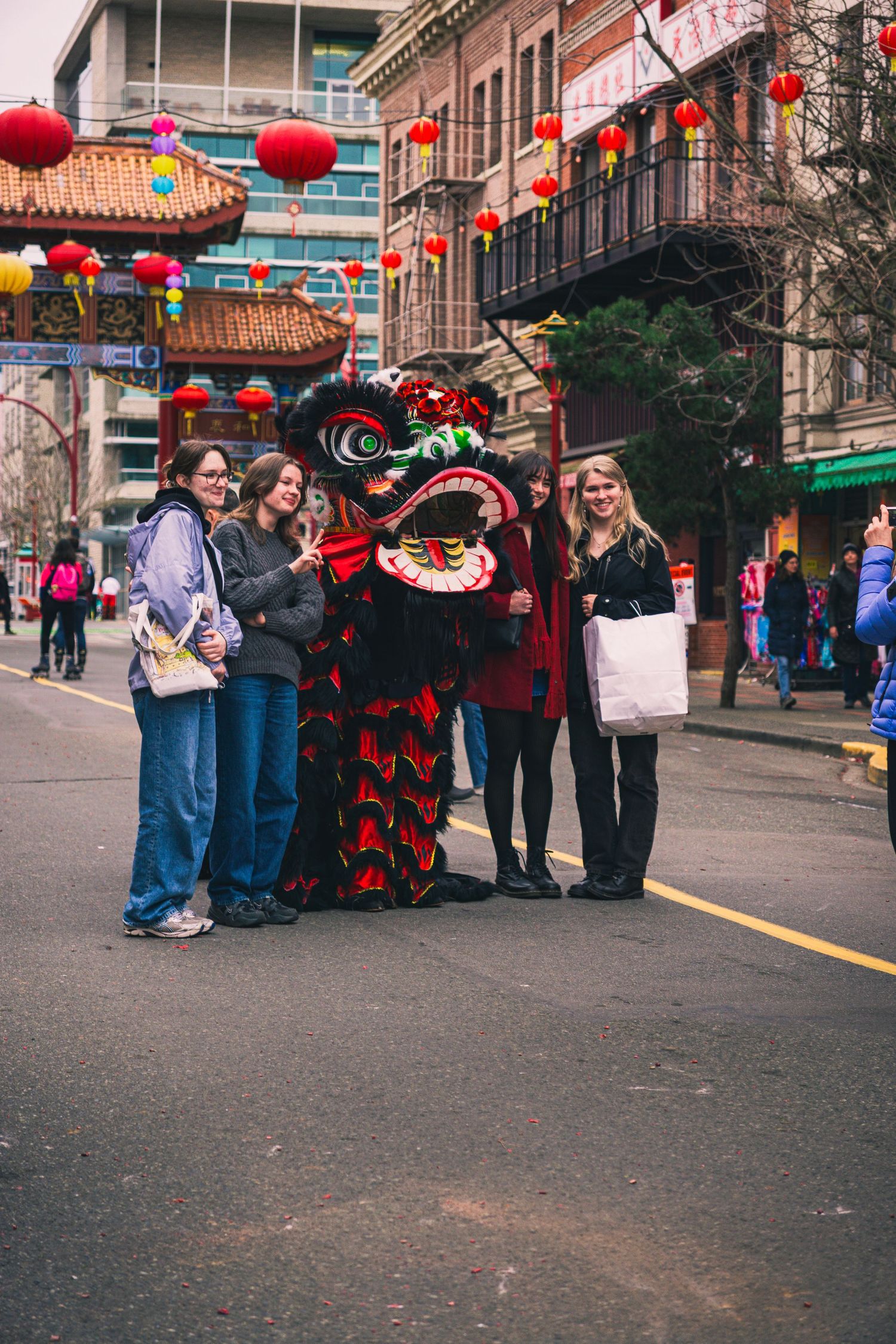 Candid crowd shot of group of people with dragon costume performers in the Awakening Chinatown Festival
