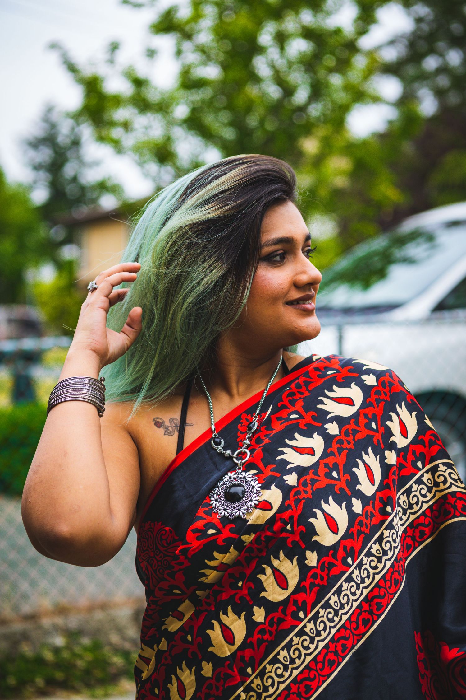 Creative portrait of Indian woman in red sari framed with natural light in Victoria, Canada