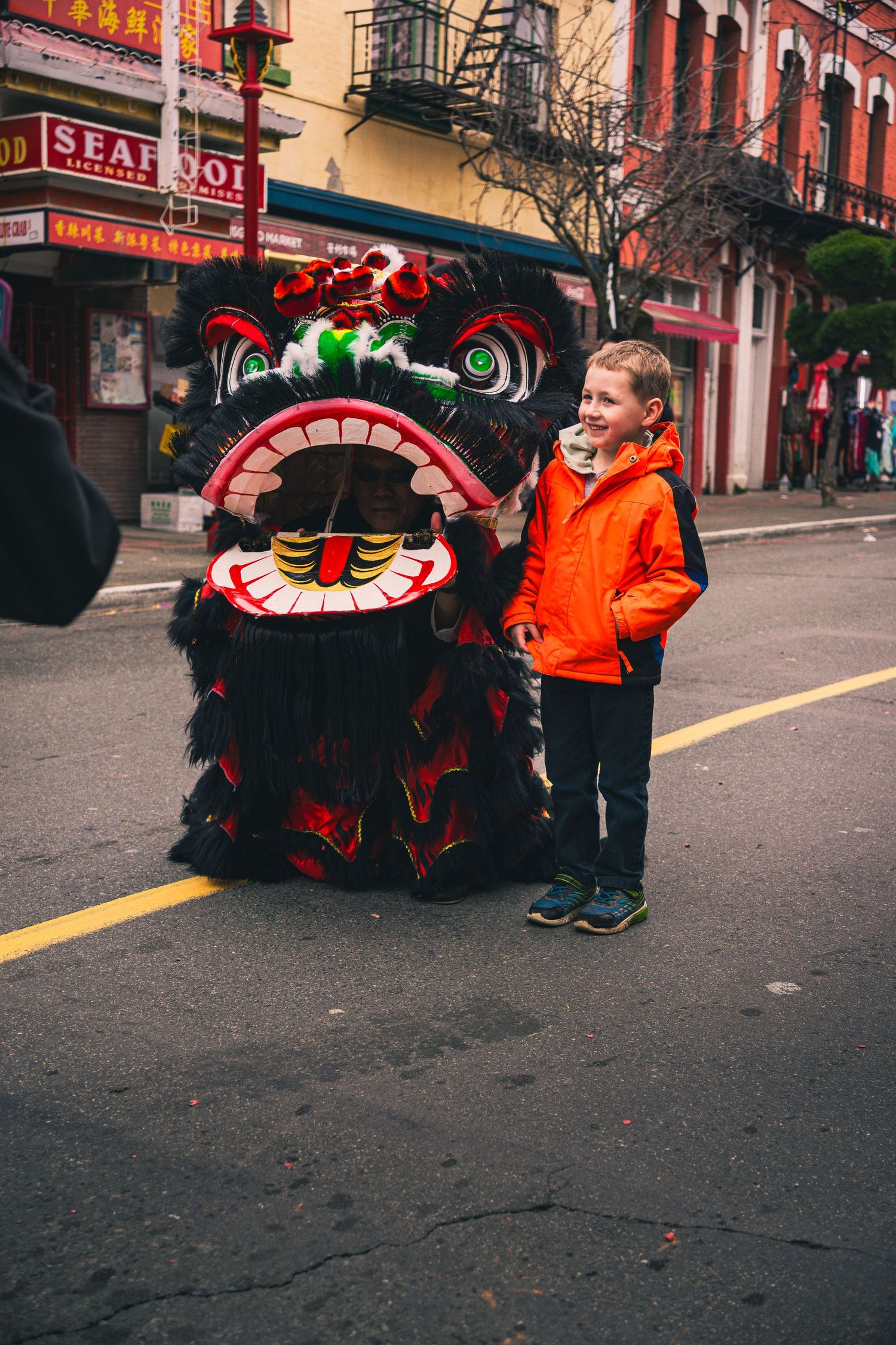 Kids posing with lion dancers at Victoria’s Awakening Chinatown festival