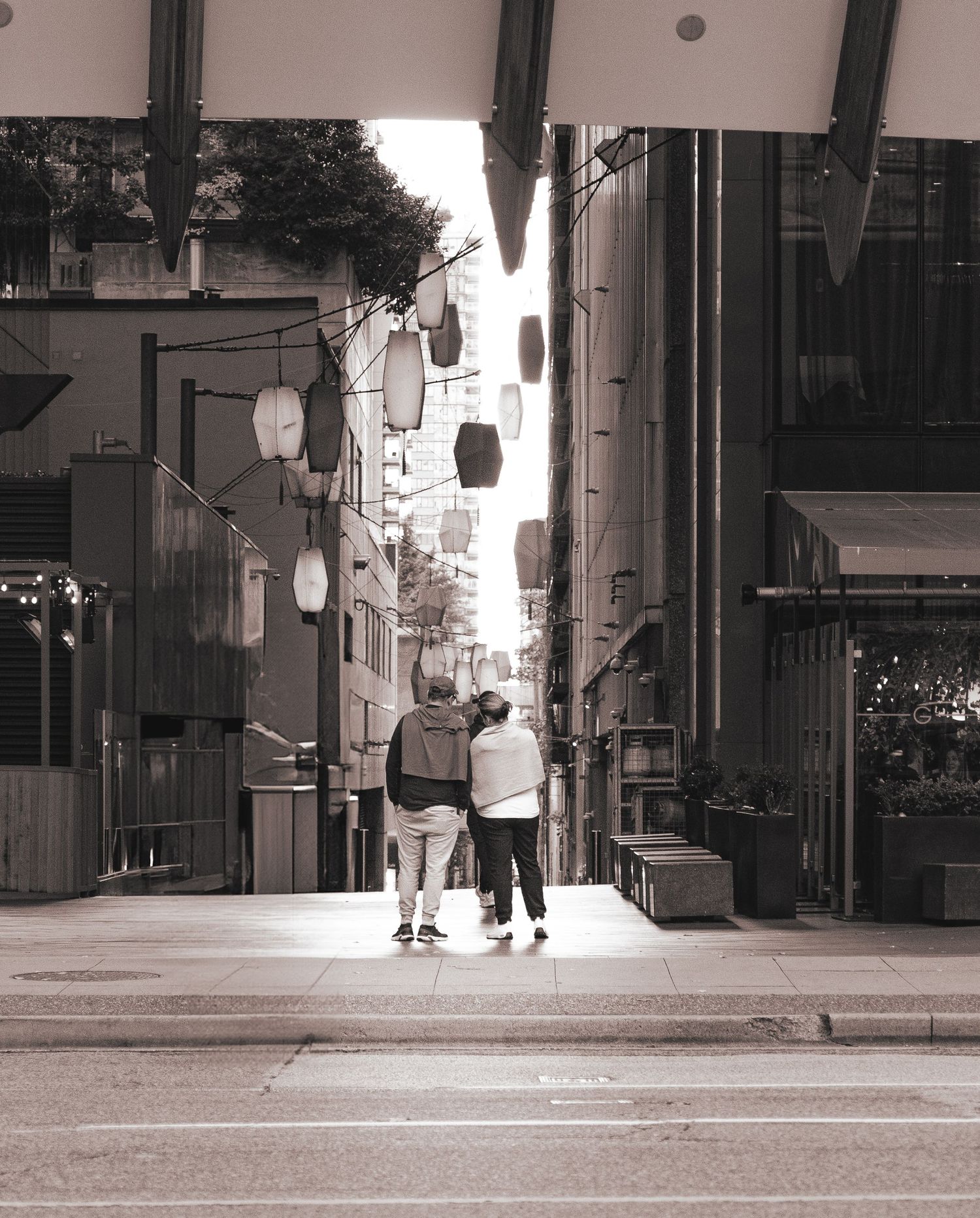 Couples together looking at an alley in Vancouver posing together on a cozy night