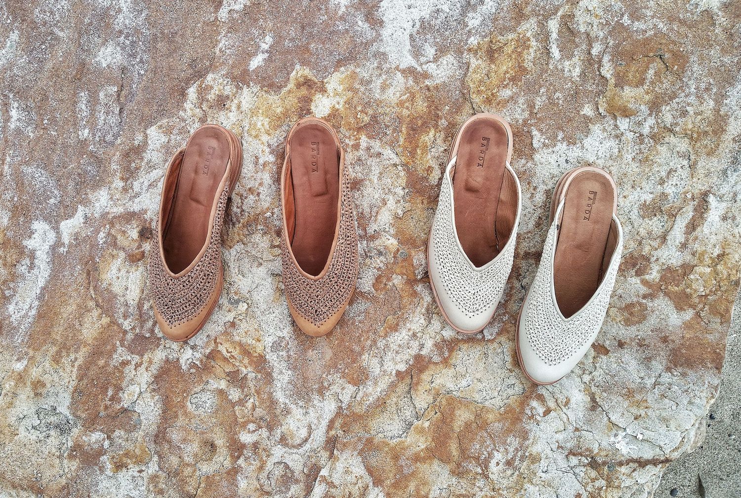 Fotografia de produto. dos pares de sandalias desde vista cenital sobre una roca en tonos ocre y blancos