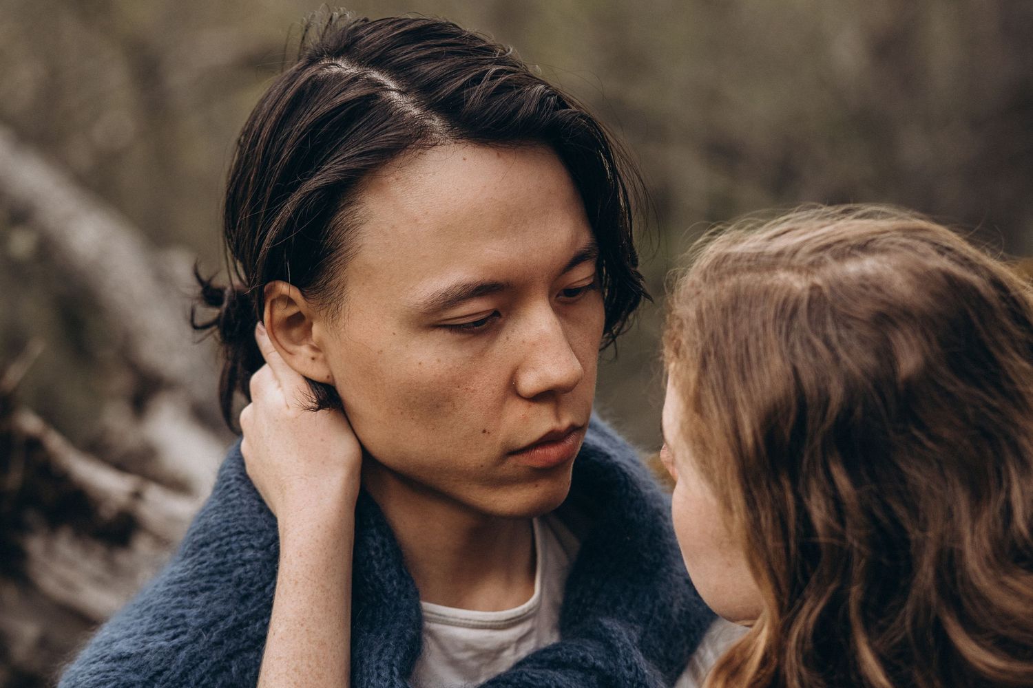Tender moment captured between two people in an outdoor setting.