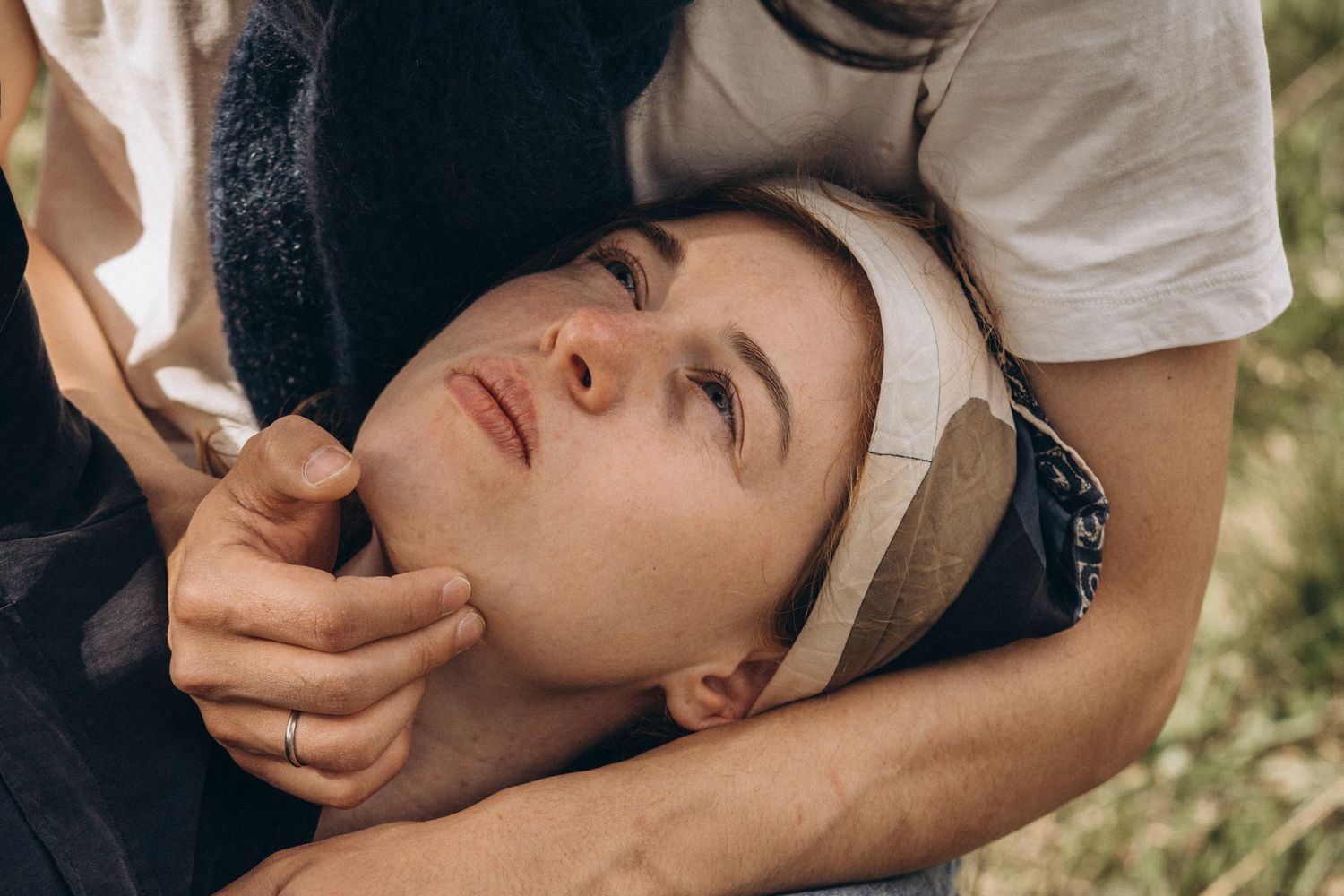 Close-up of an intimate moment between two people in natural lighting.