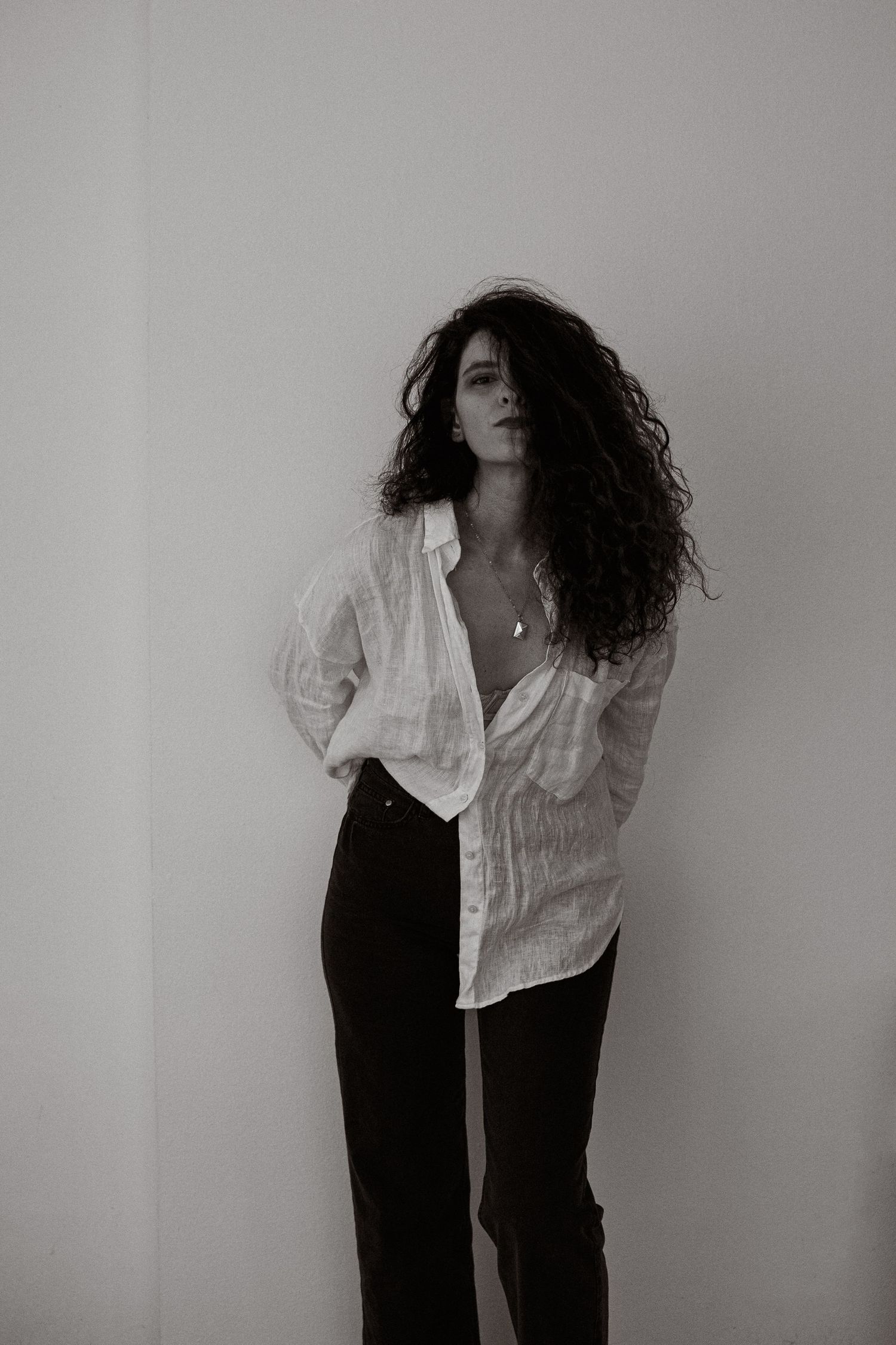 Artistic black and white portraits showing movement and flowing white clothing against a minimalist background.