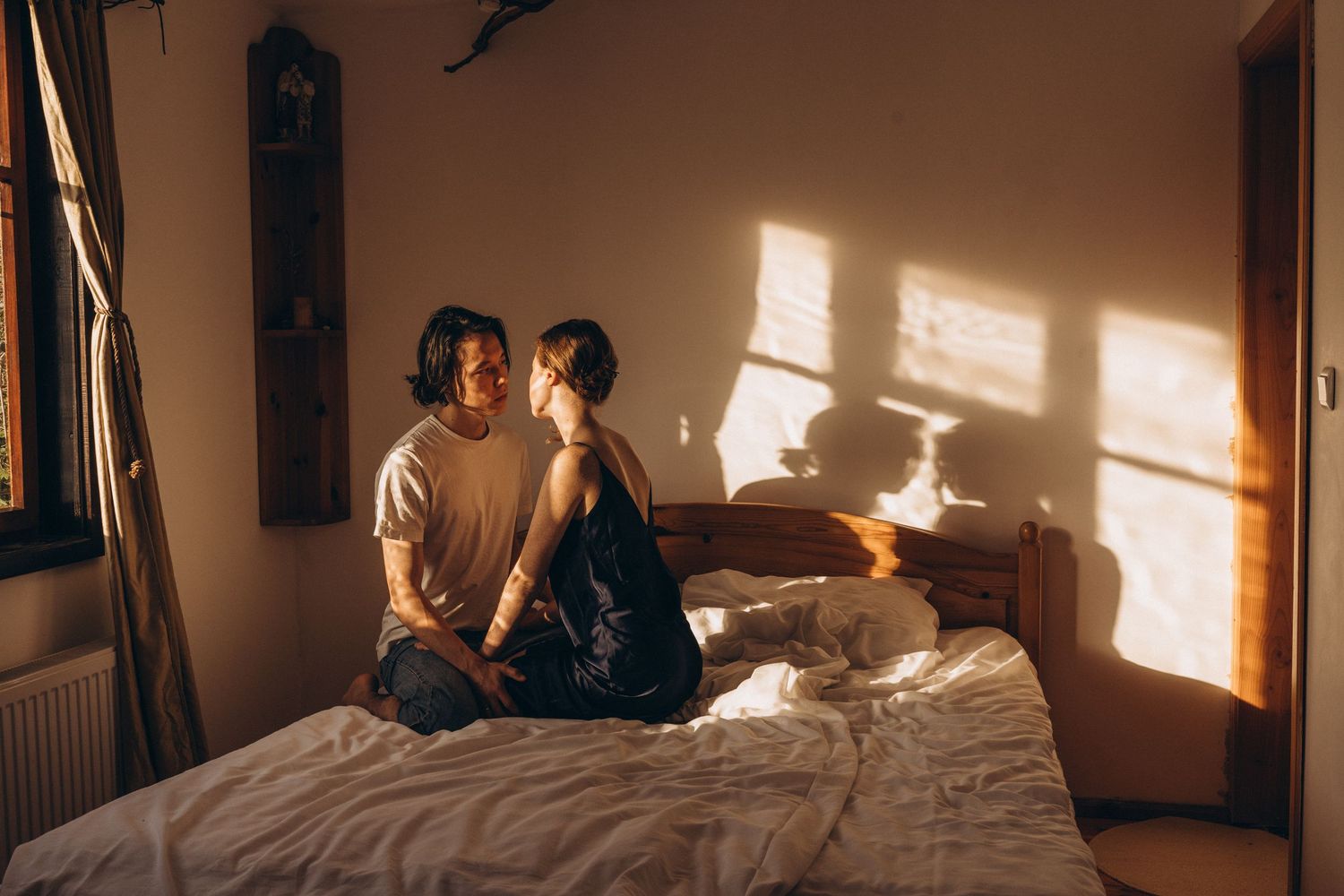 Sunlight streaming through windows creates dramatic shadows in a warm-toned interior space.