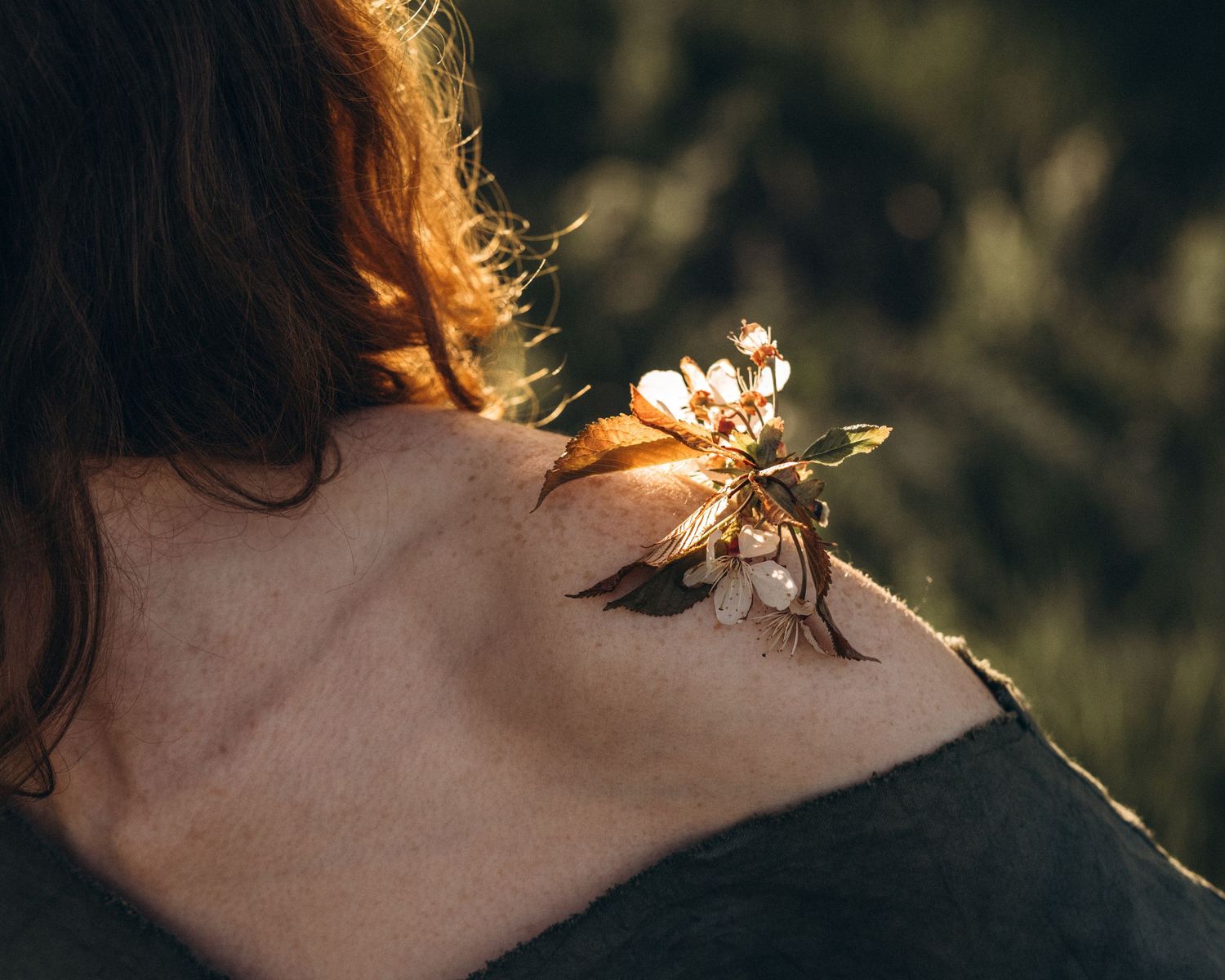 Close-up detail of sunlit hair and neck in warm golden evening light.