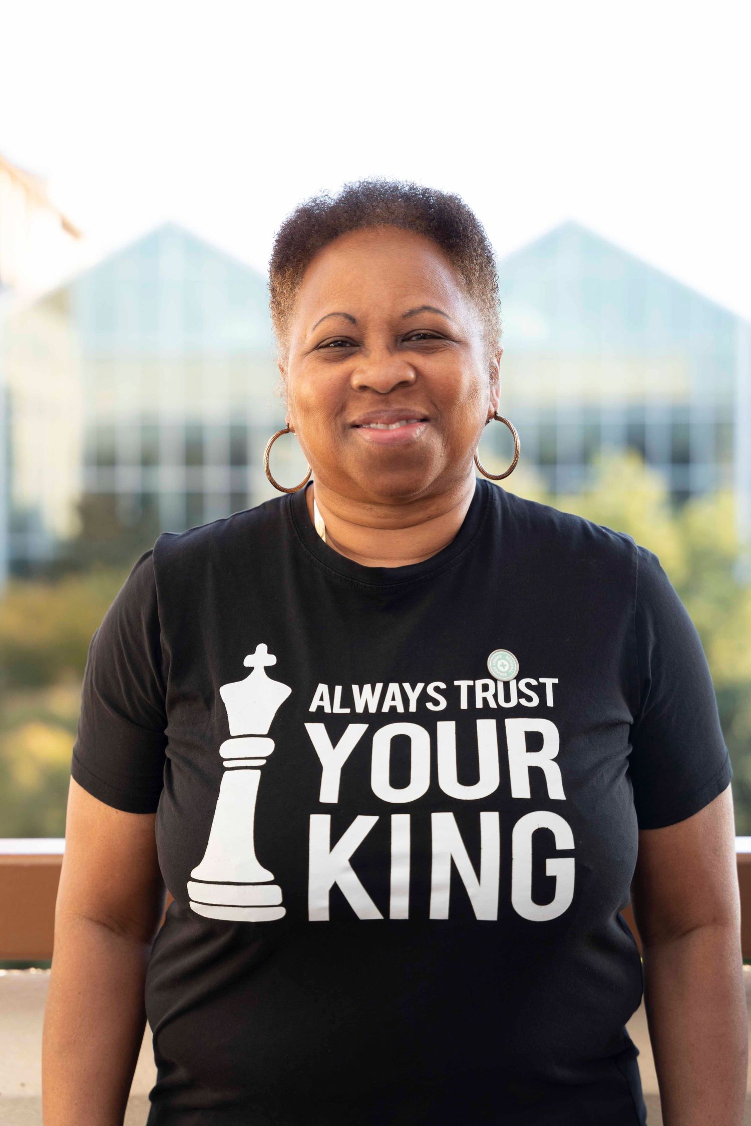 Three views of someone wearing a black chess-themed t-shirt with 