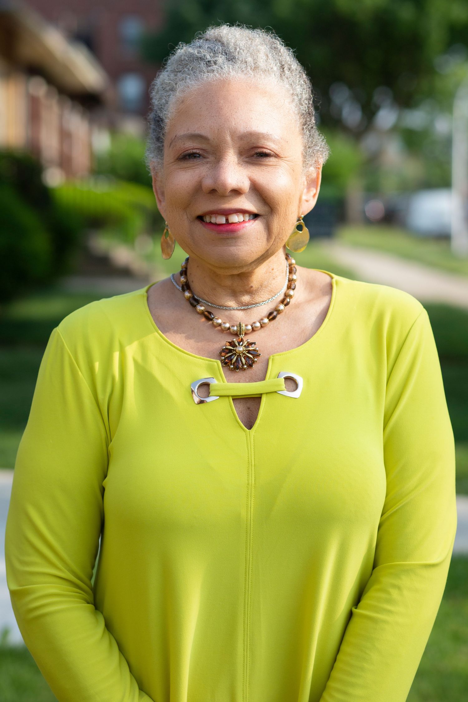 Portrait series featuring bright lime green top and statement necklace.