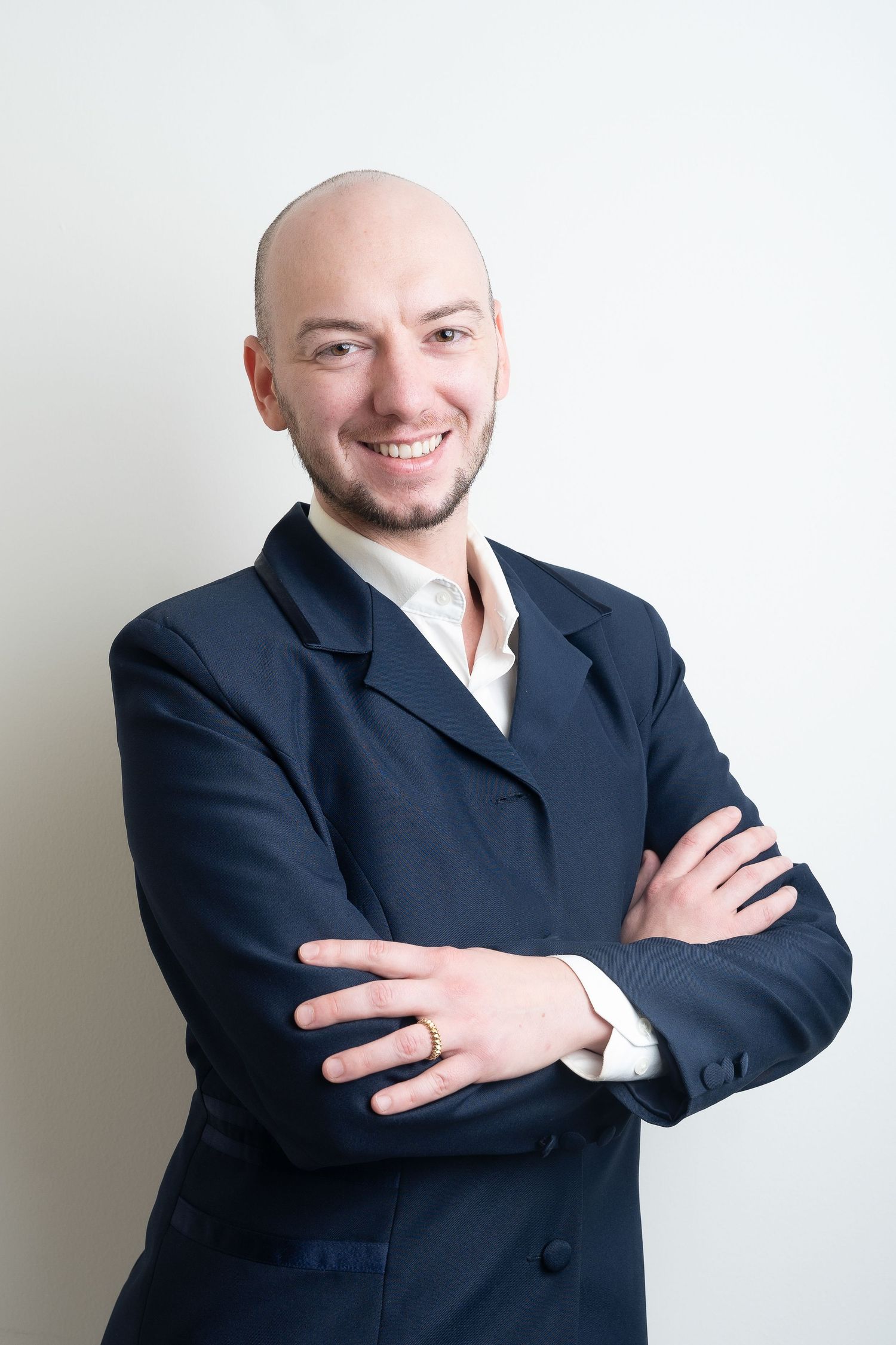 Professional headshots of person in dark suit jacket against white background showing different friendly poses.