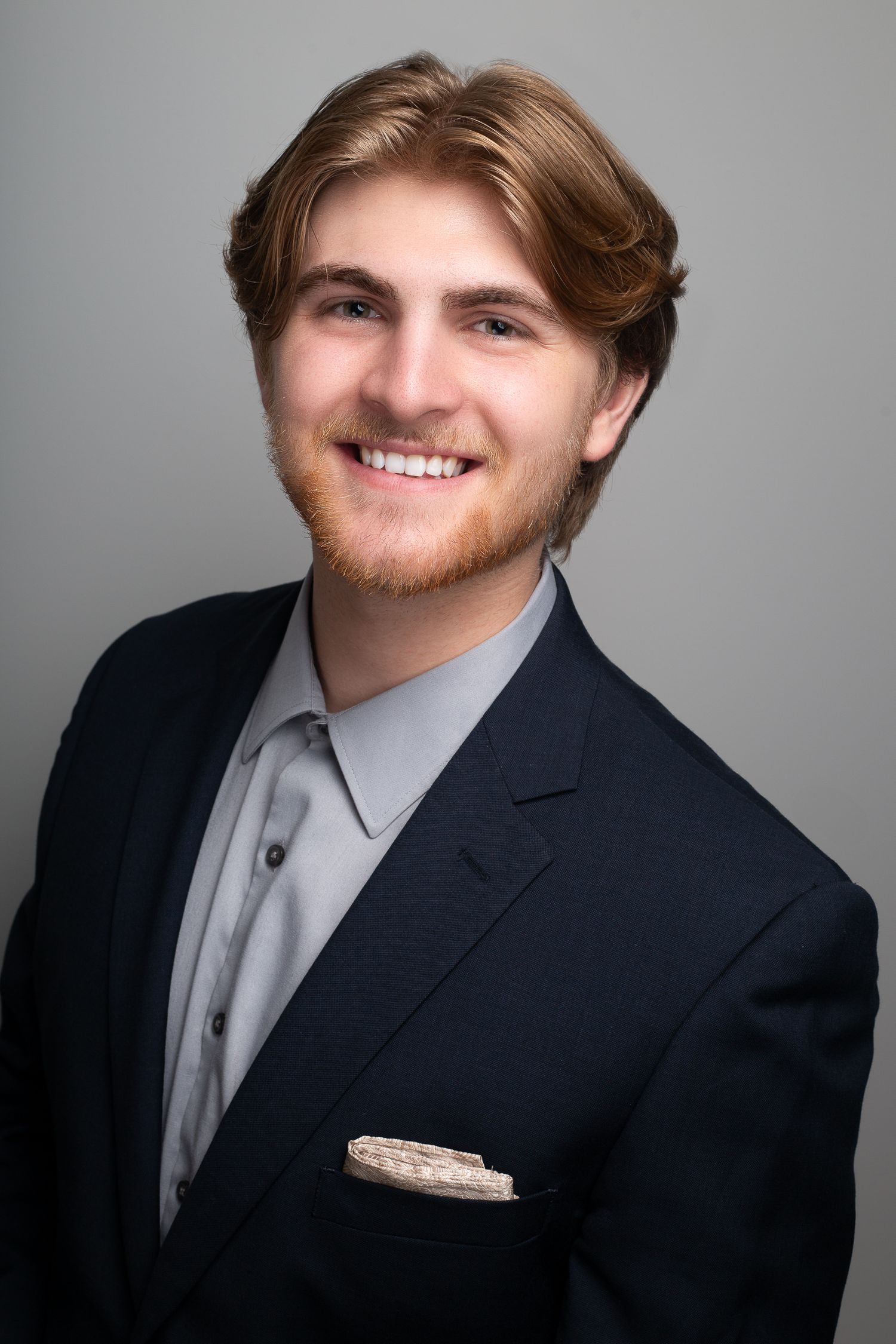 Professional portrait series showing different angles of person in navy suit and gray tie.