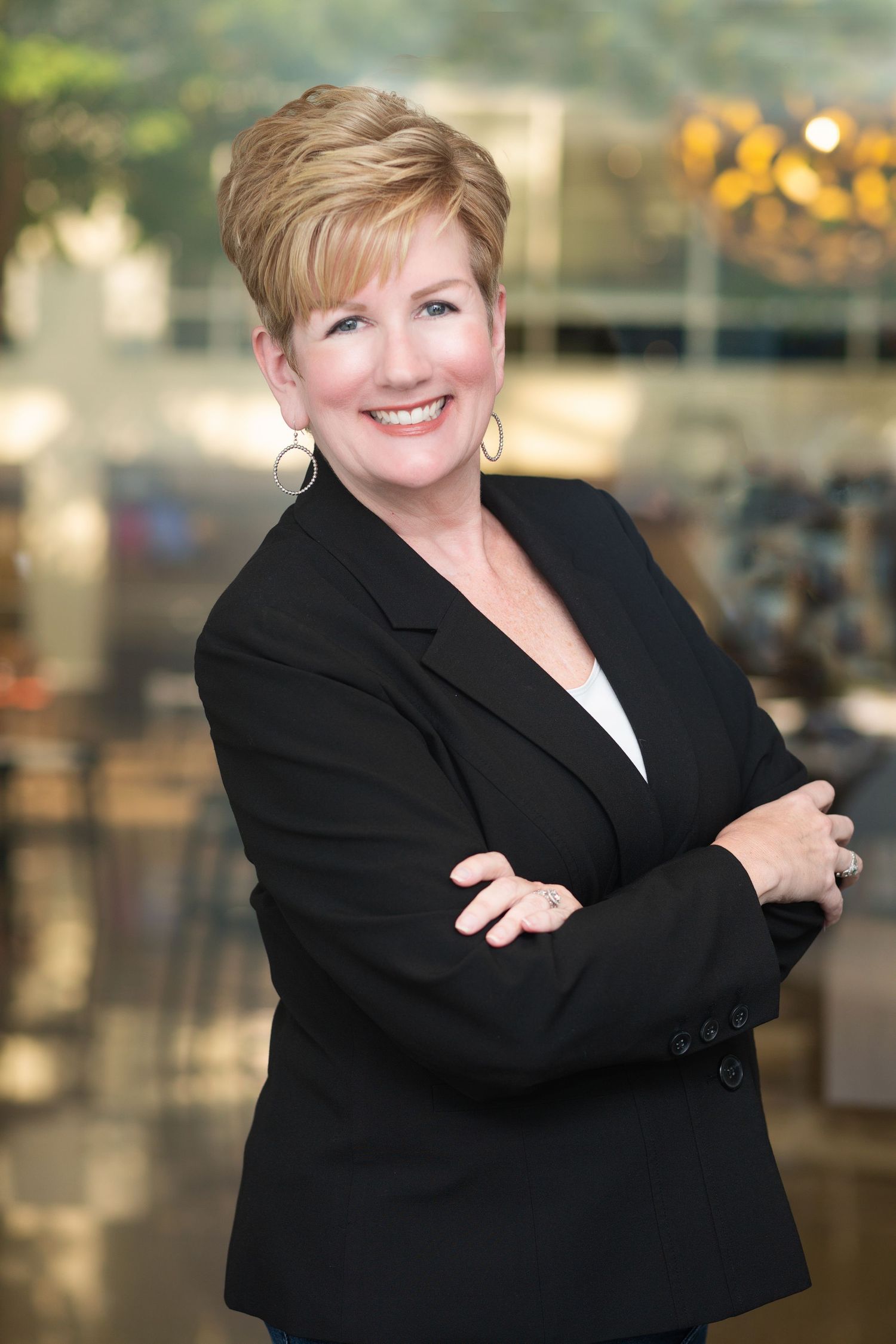 Professional headshots showing person in black blazer against blurred background.