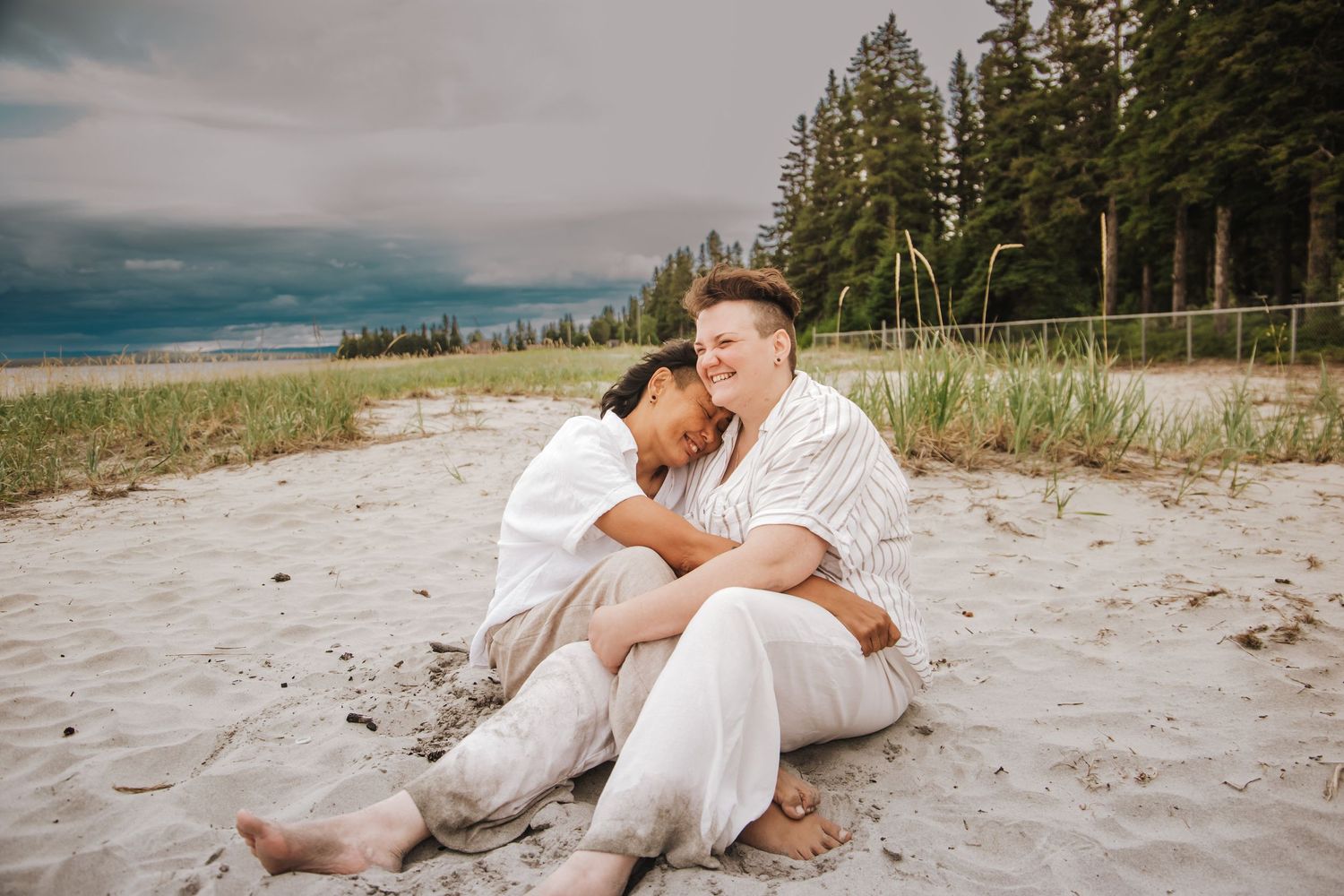 Snuggled in the sand. A couple shares a sweet moment reminiscing their wedding day