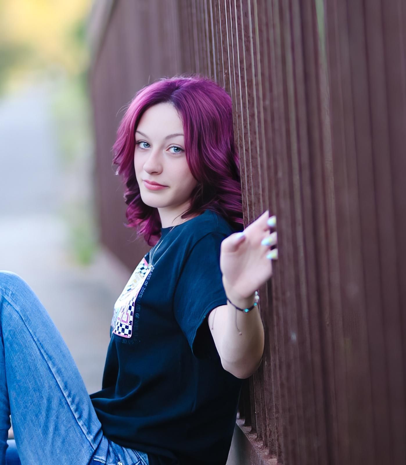 Artistic portrait sequence showing person in black top and jeans against wooden fence in warm lighting.