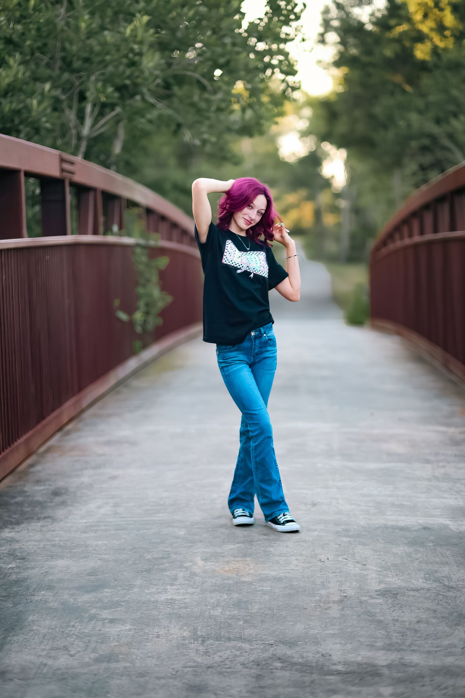 A sequence of playful poses on a wooden bridge path surrounded by green foliage.