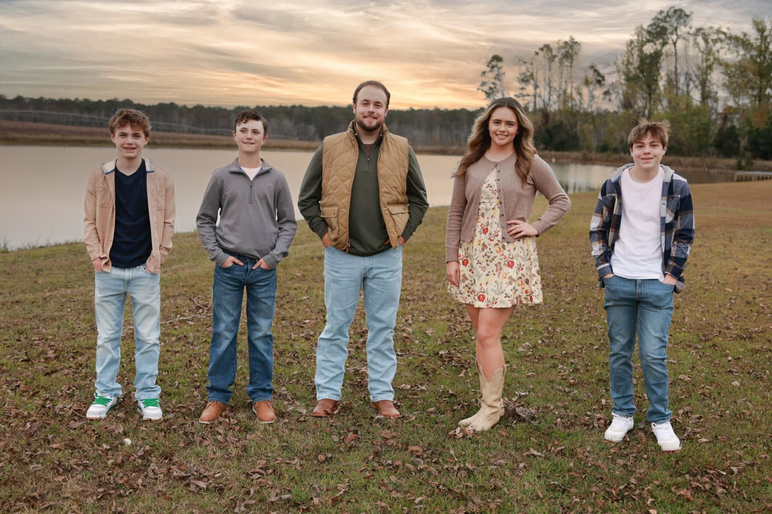 Casual family photo showing legs and feet of group members standing in a row outdoors.