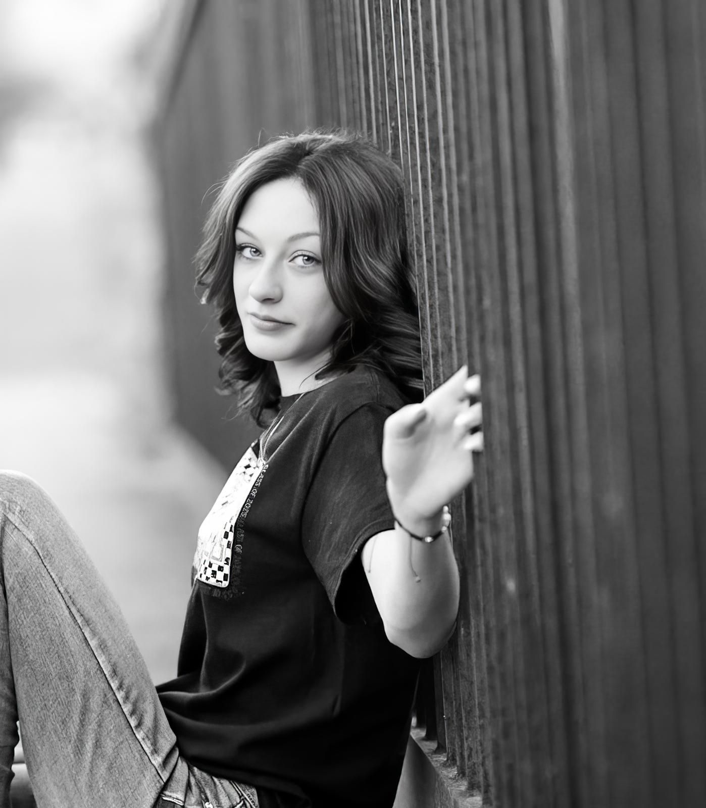 Black and white portrait series showing movement and casual poses against vertical lines.