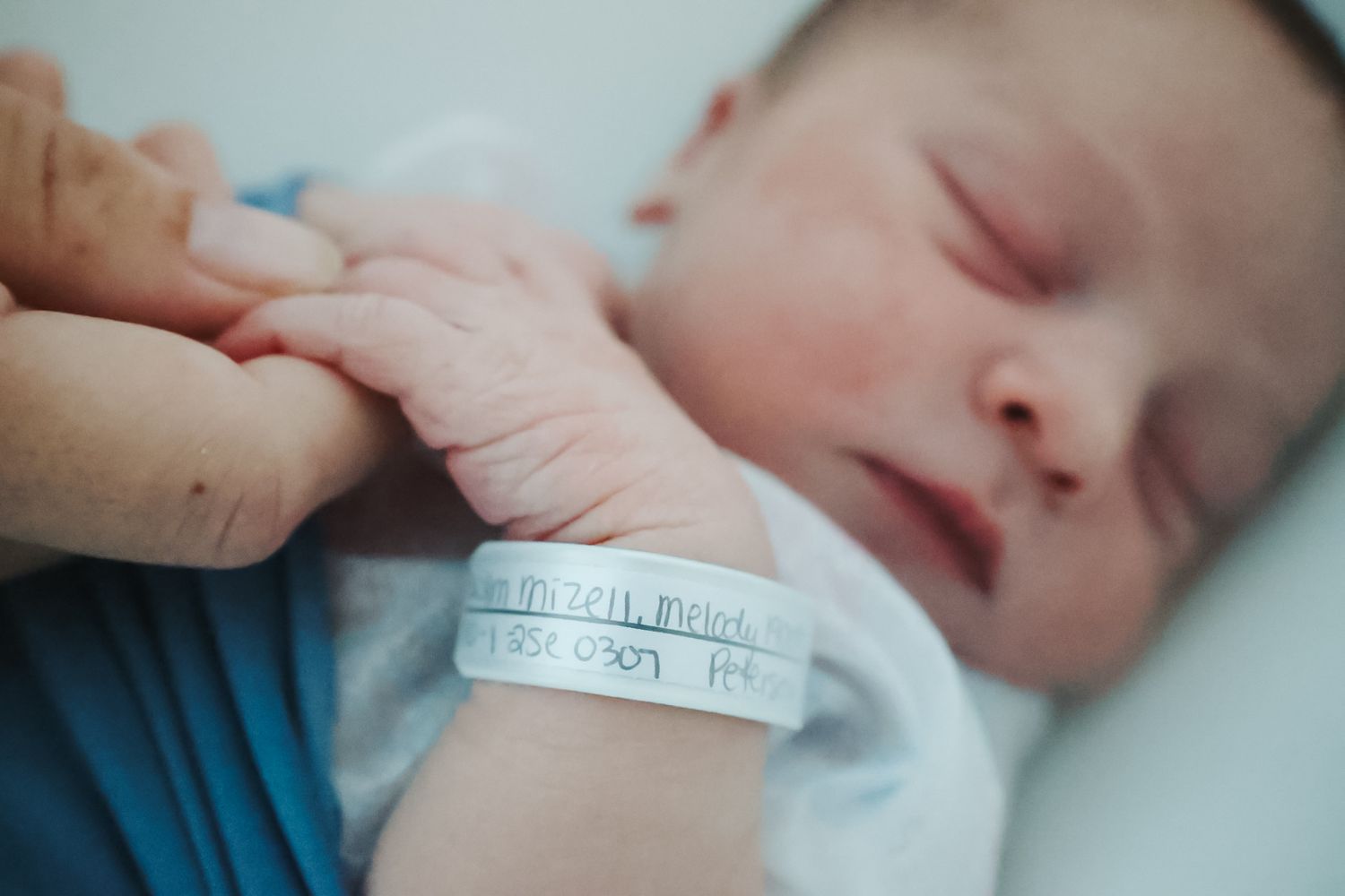 Close-up shots of a newborn baby in hospital with identification bracelet and medical care details.