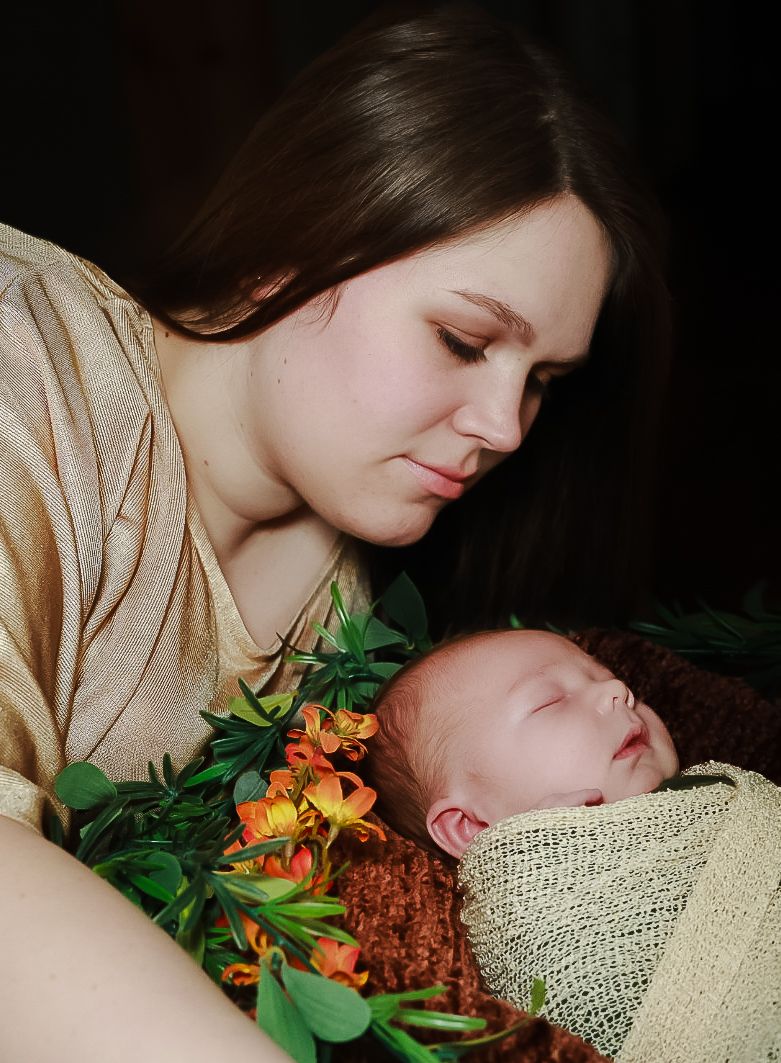 A tender moment captured with orange lilies and green foliage decorating a peaceful scene in warm lighting.