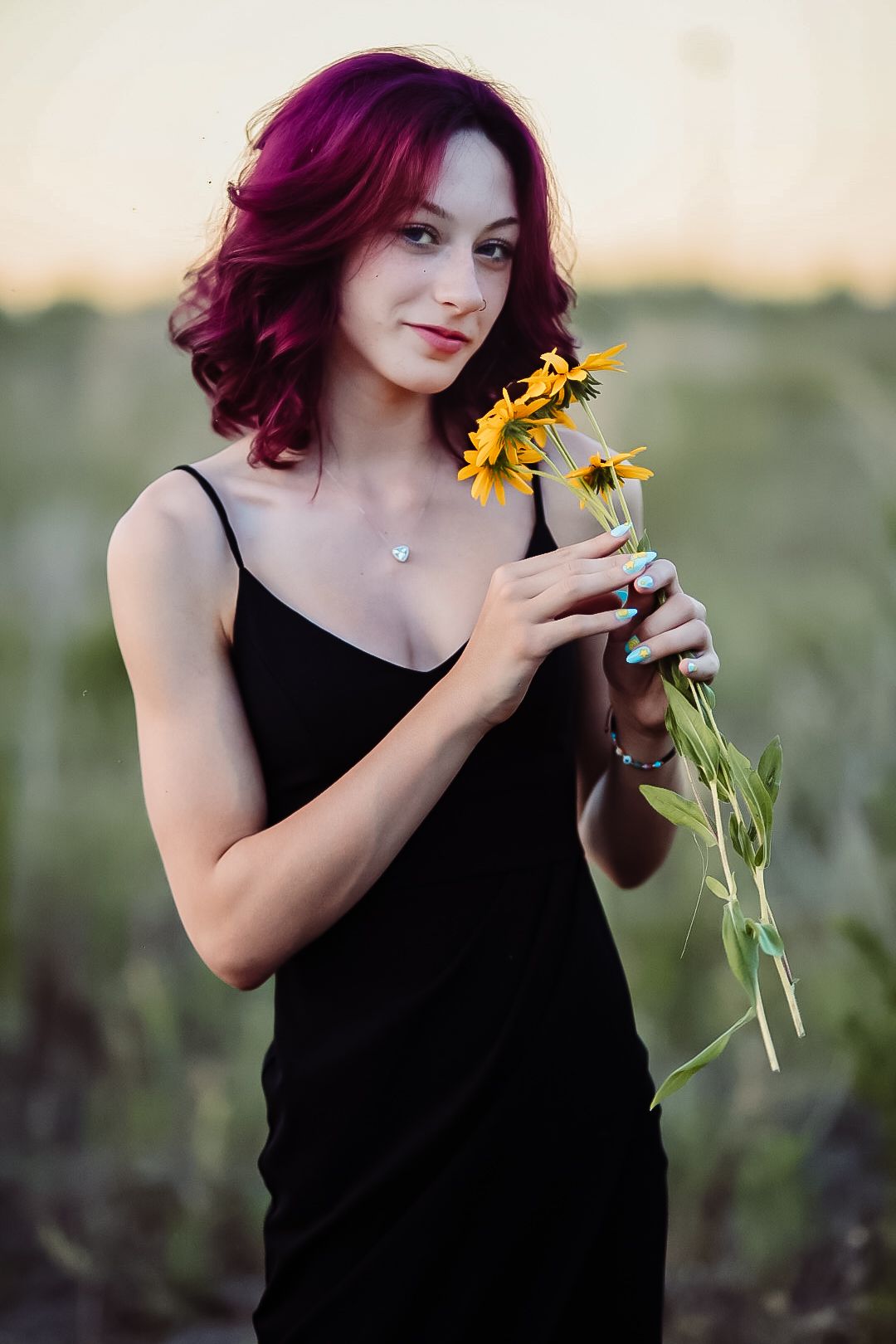 A series of artistic portraits featuring vibrant magenta hair and sunflowers against a natural outdoor background.