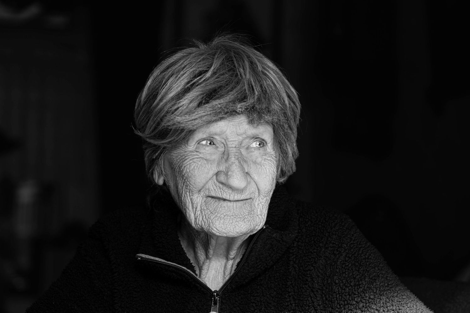A series of black and white portrait photographs arranged in a horizontal row showing the same person at different angles.