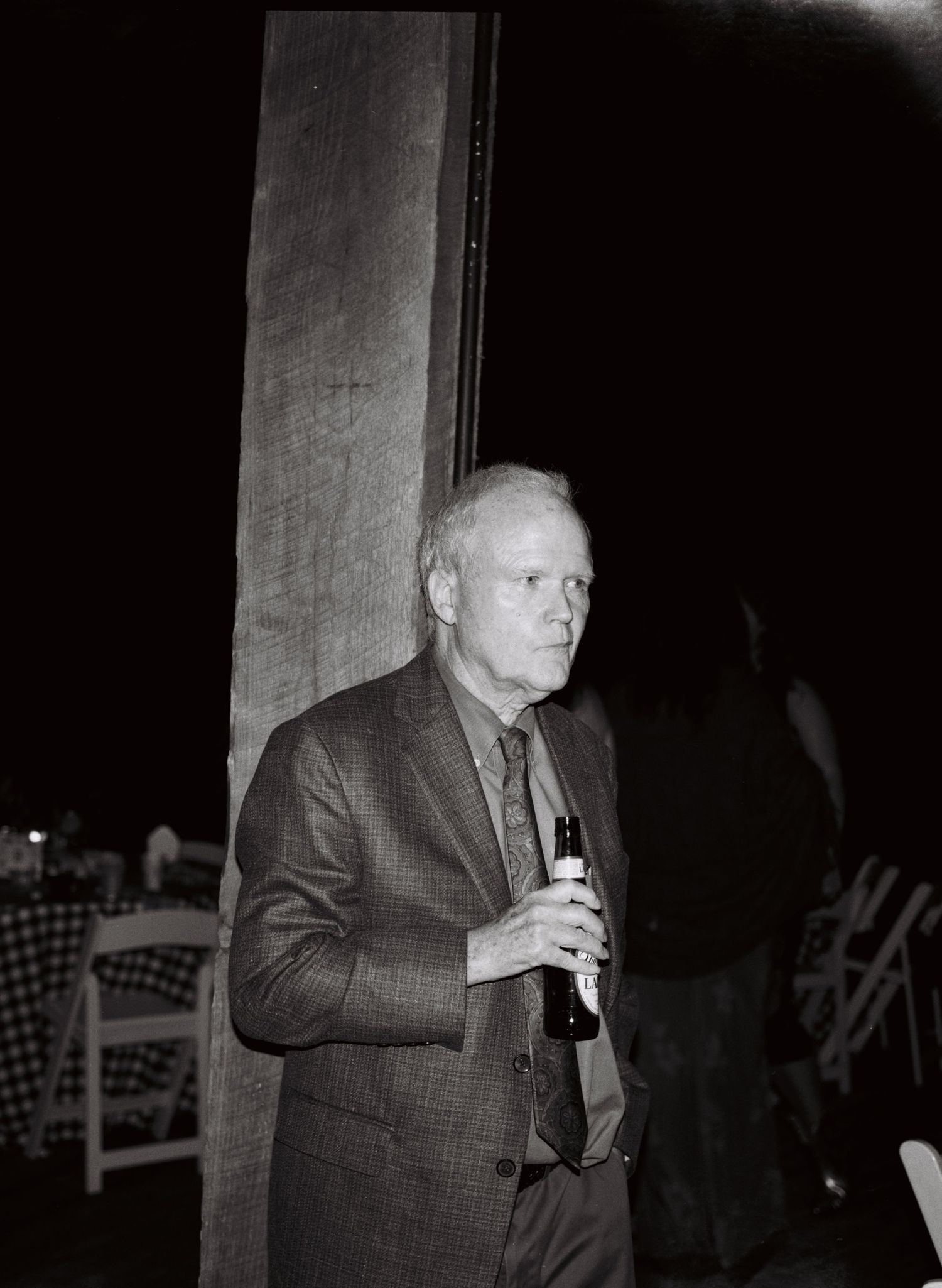 A black and white photo sequence shows someone in a suit taking a drink from a glass in low lighting.