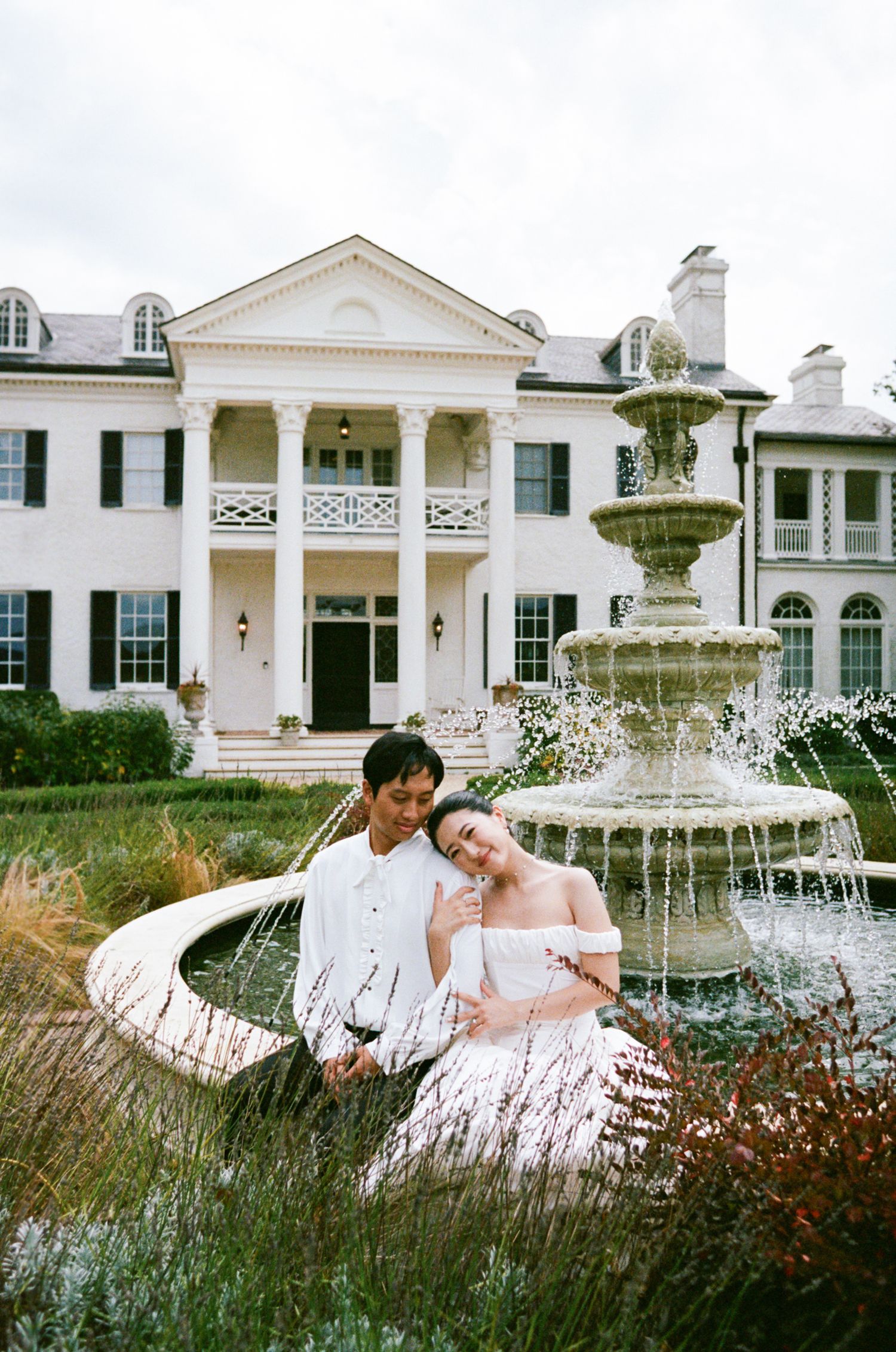 Elegant white mansion with fountain and garden features shown in multiple views during a wedding photoshoot.