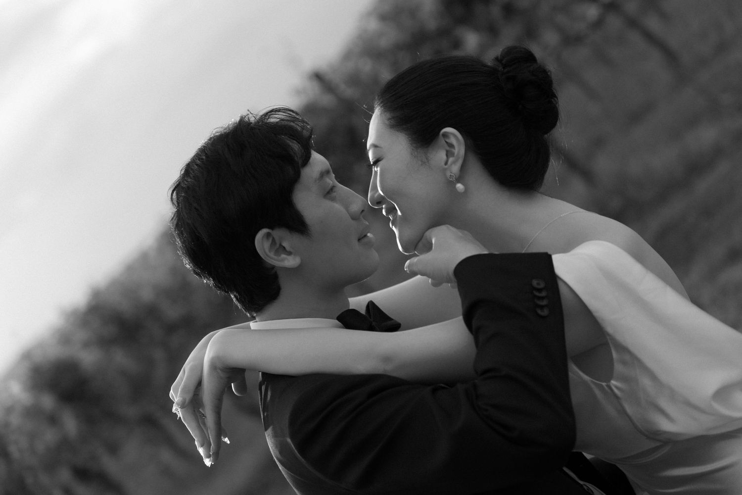 A series of black and white photos showing a couple embracing and sharing intimate moments together.